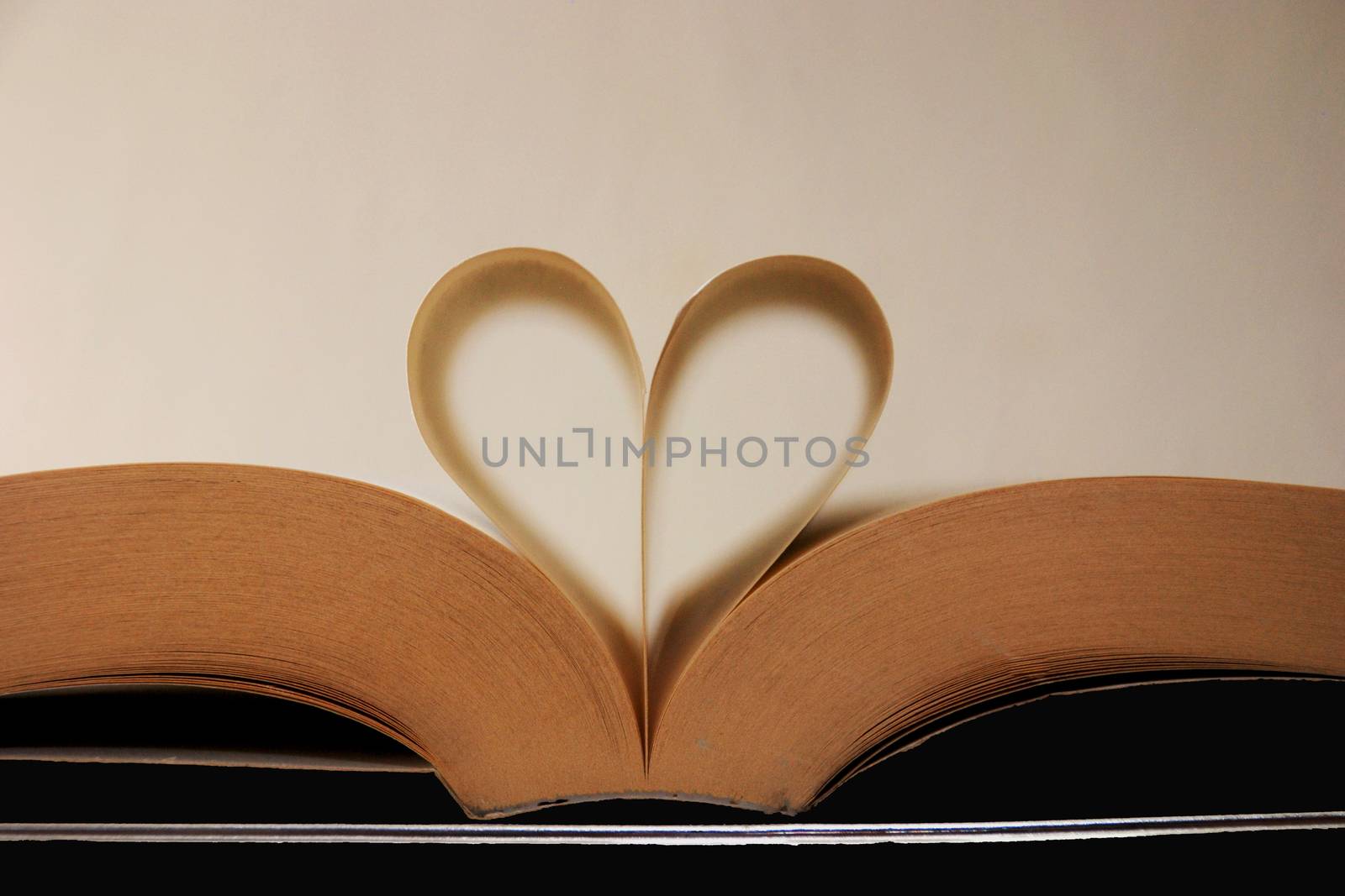 Book pages in the shape of a heart. I like to read, reading.