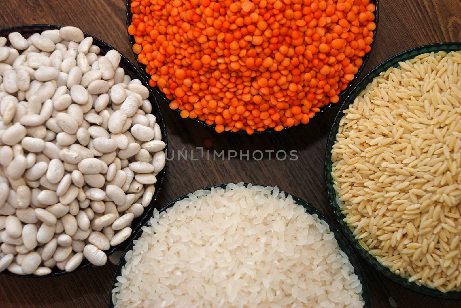 in a glass bowl of rice, red lentils, haricot beans and barley noodles