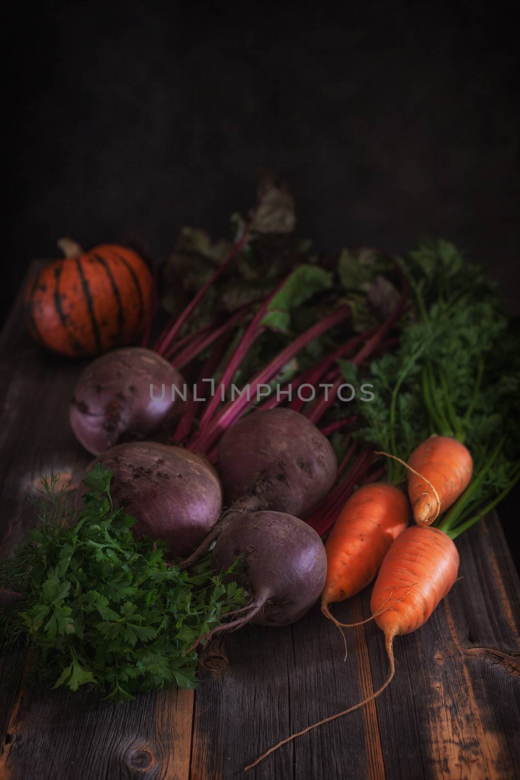 Fresh vegetables and pumpkin against the background of old boards