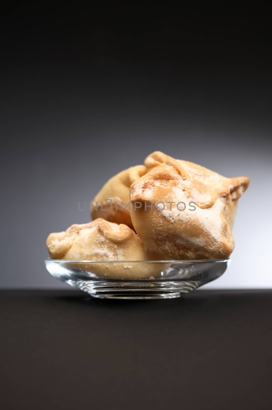 Freshness pastry on glass saucer against nice dark background