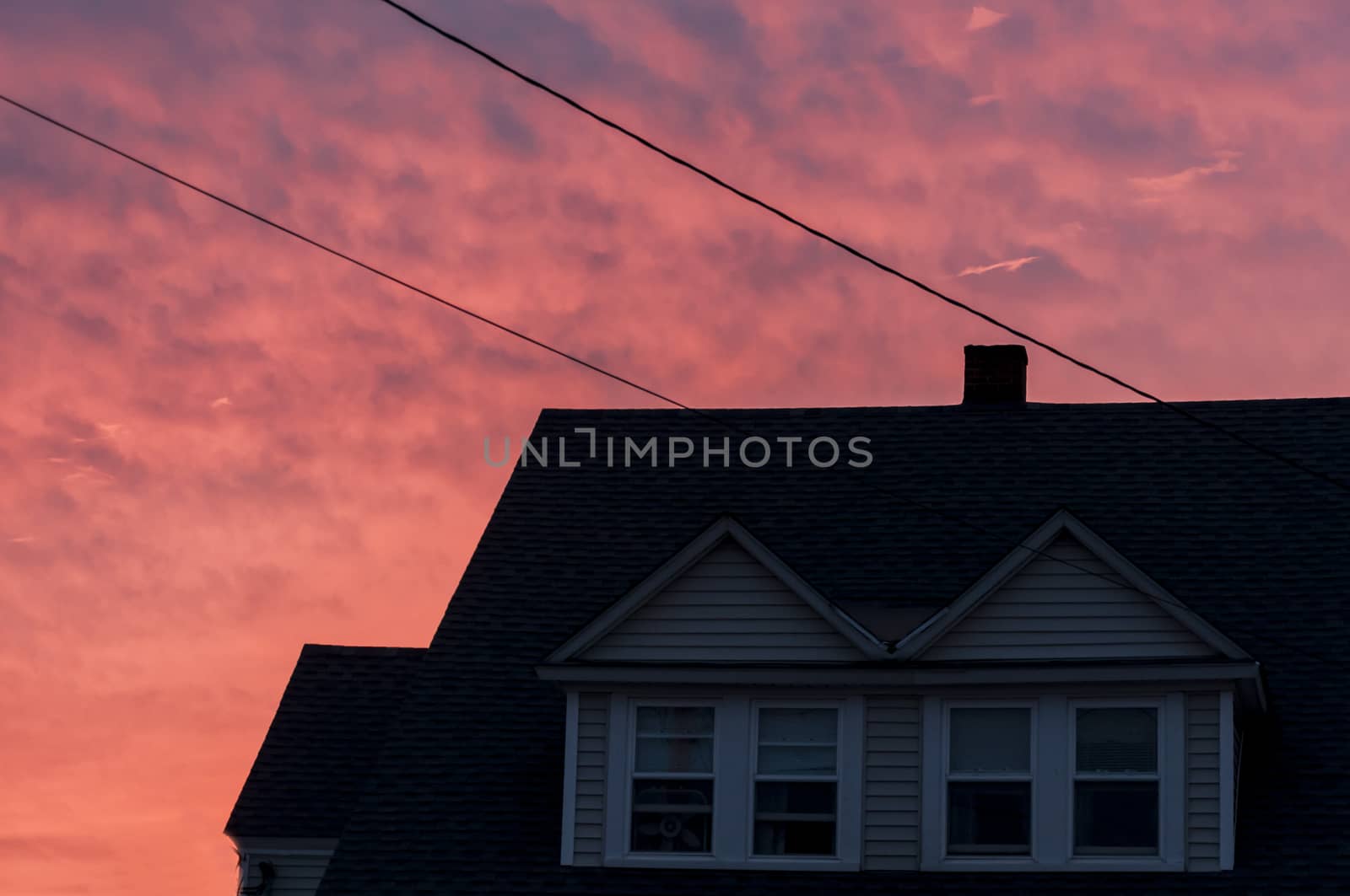 sunset creates an orange tone to the houses as the shadows deepen in Maine