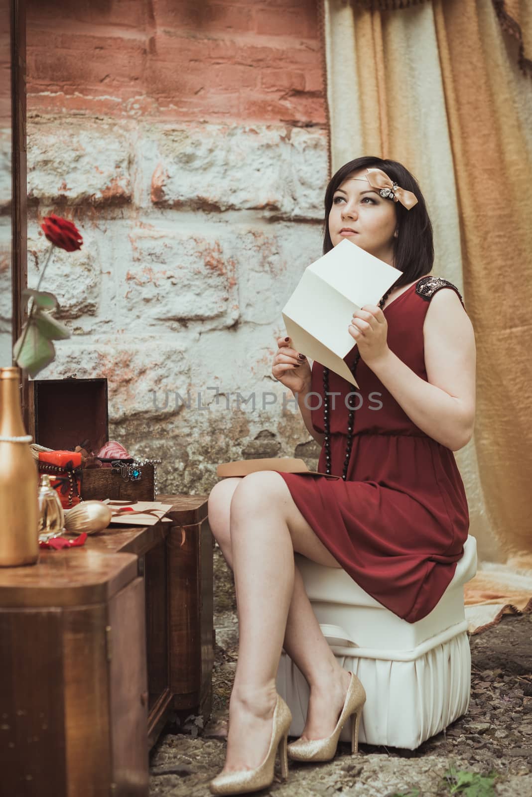 retro girl sitting at a dressing table with a letter in your hands