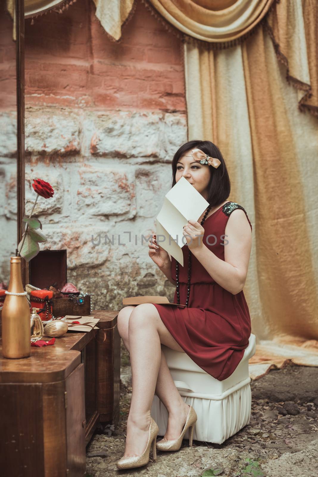 retro girl sitting at a dressing table with a letter in your hands