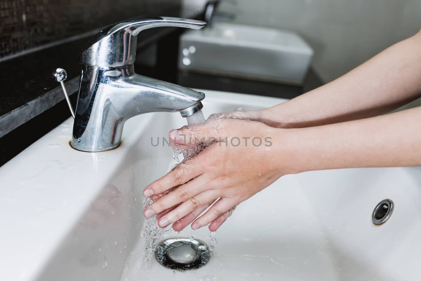 Close-up Washing of hands under the crane with water by nopparats