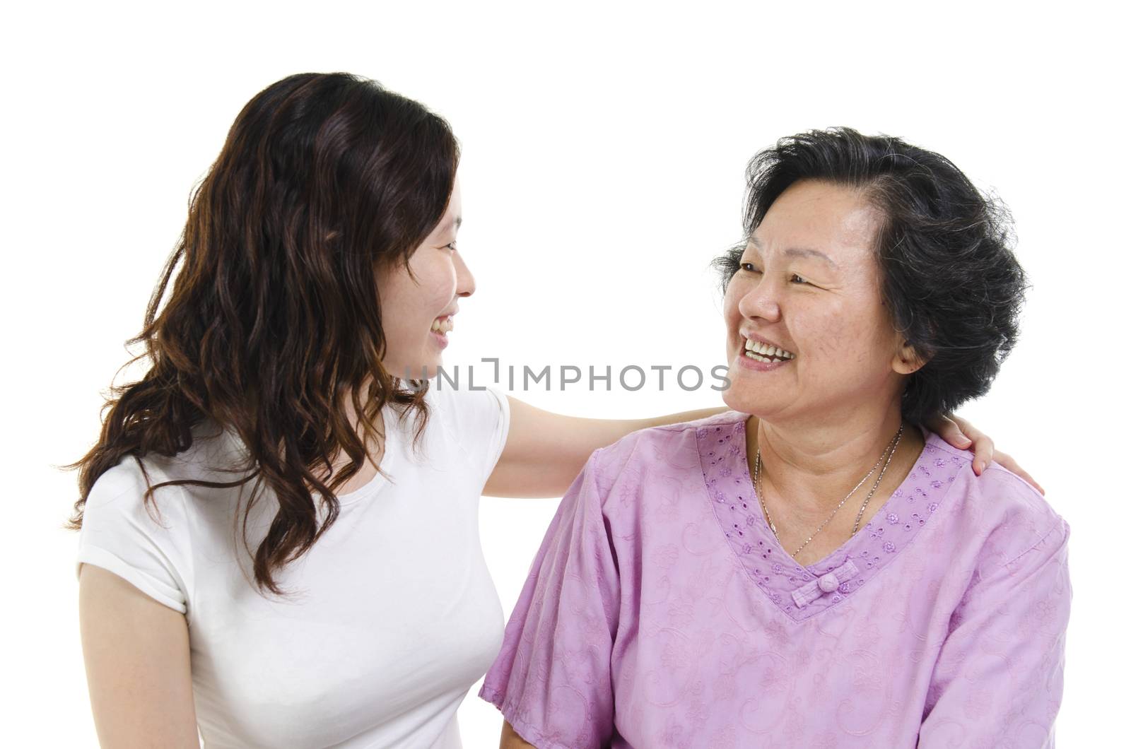 Portrait of Asian senior mother and adult daughter talking and looking at each other, isolated on white background.