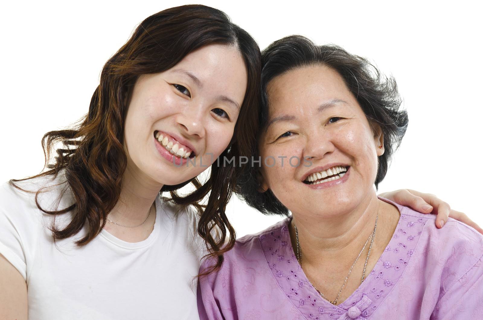 Headshot of Asian senior mother and adult daughter smiling and looking at camera, isolated on white background.