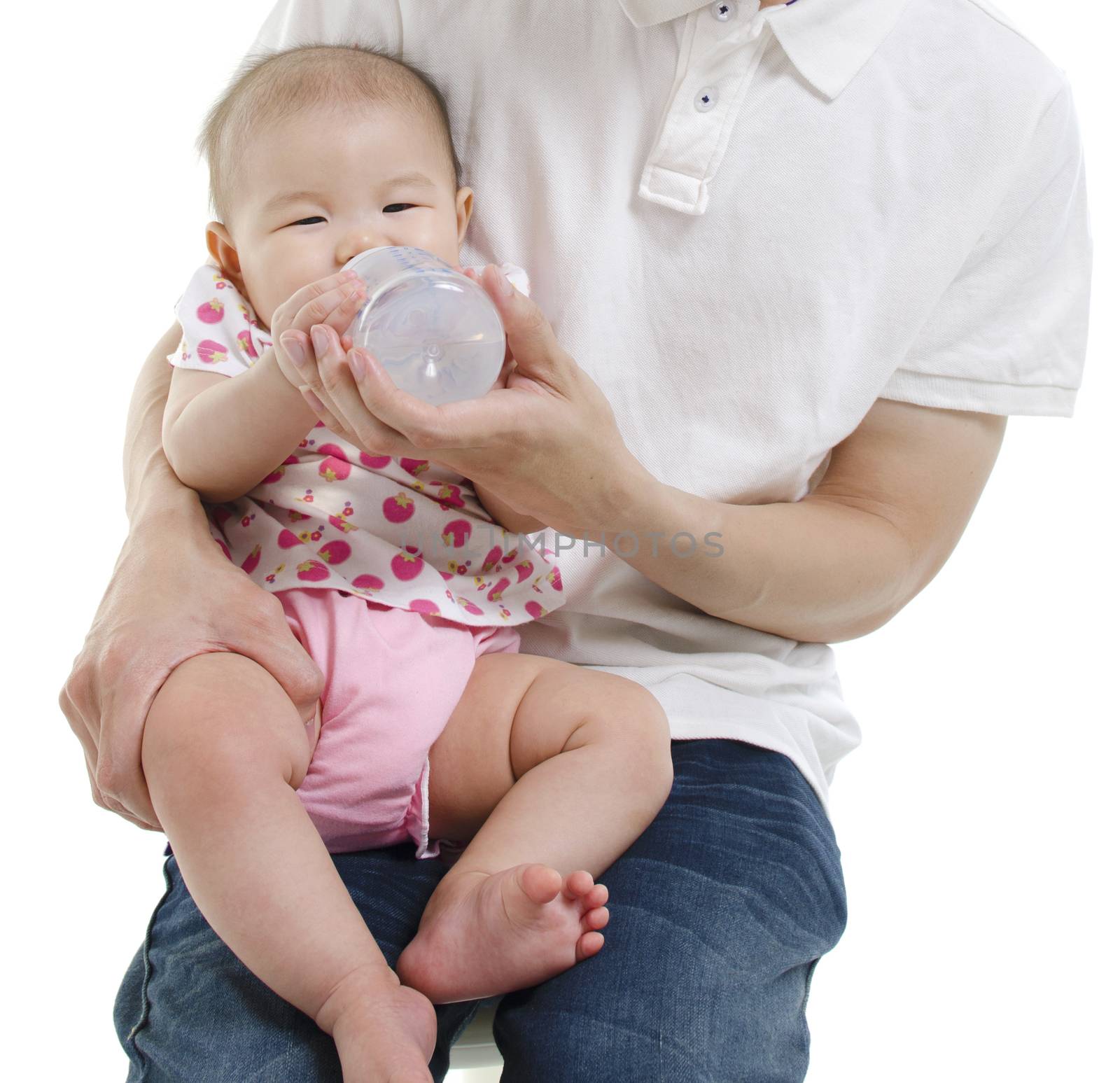 Asian father feeding baby girl drinking milk bottle, isolated on white background.