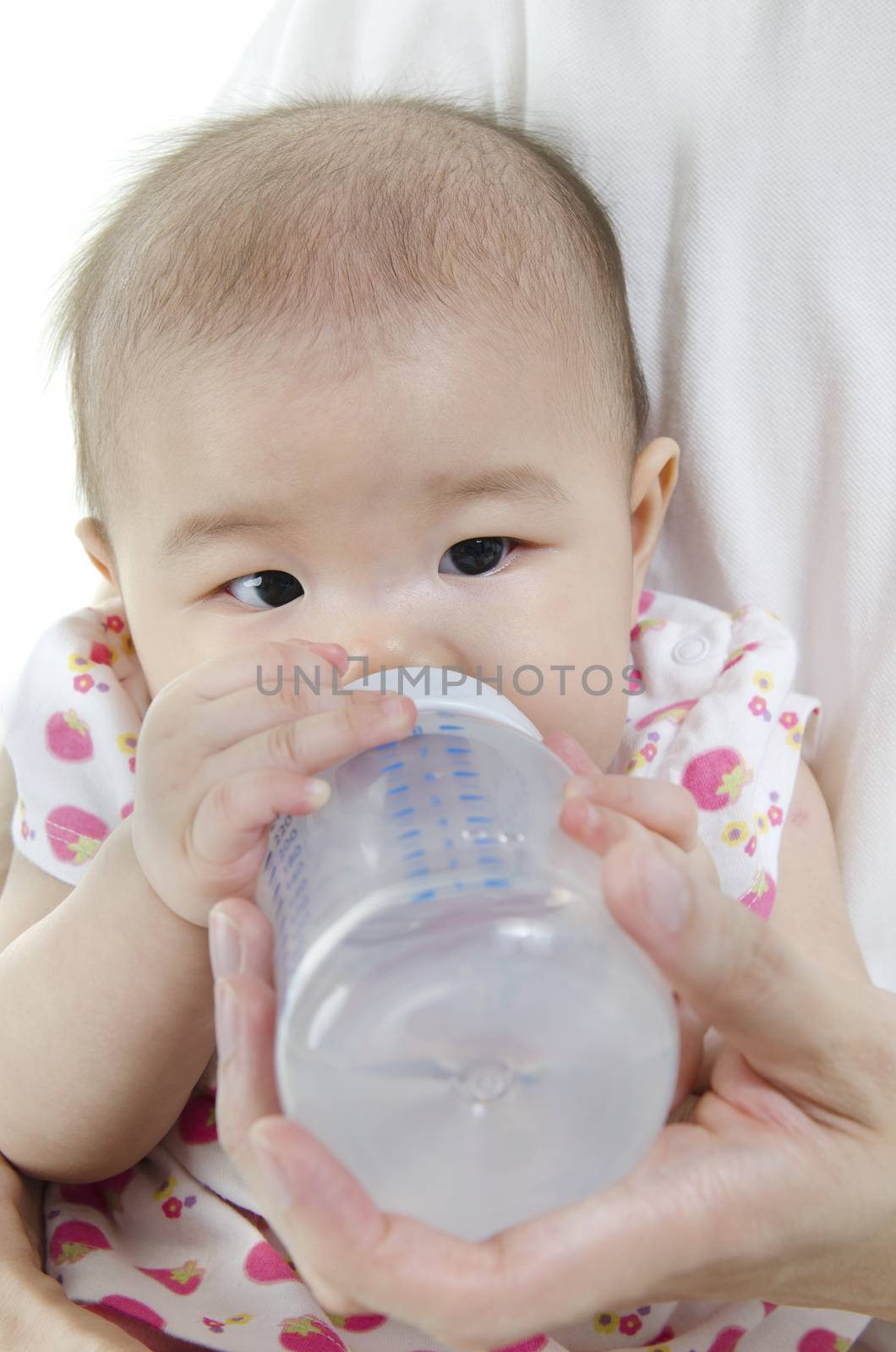 Asian father feeding baby girl drinking milk bottle.