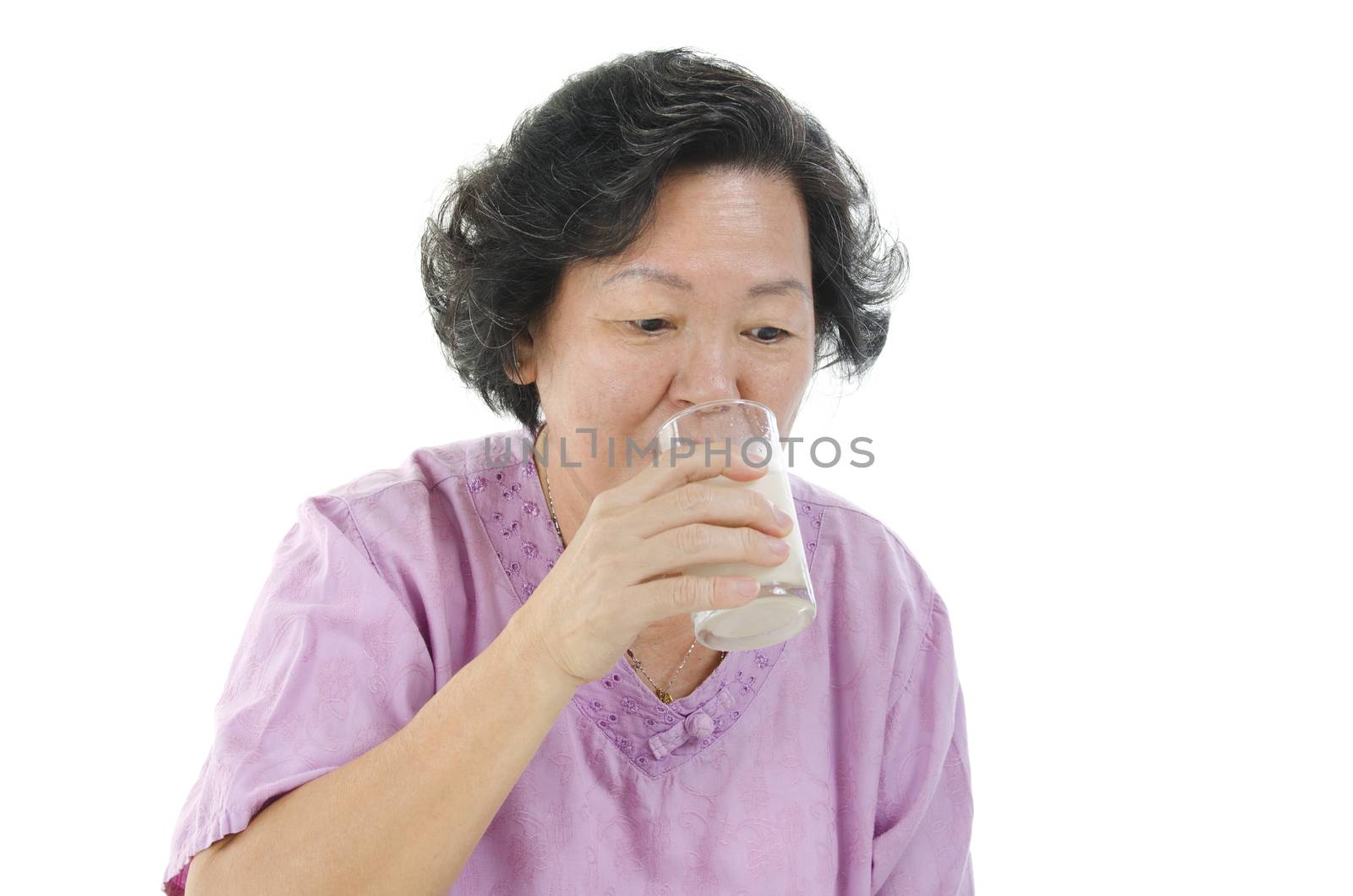 Senior woman drinking milk with glass by szefei