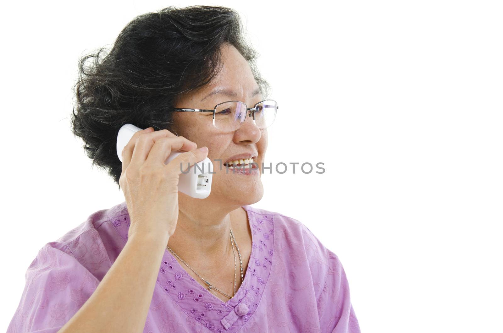Portrait of Asian senior adult woman calling on telephone, isolated on white background.