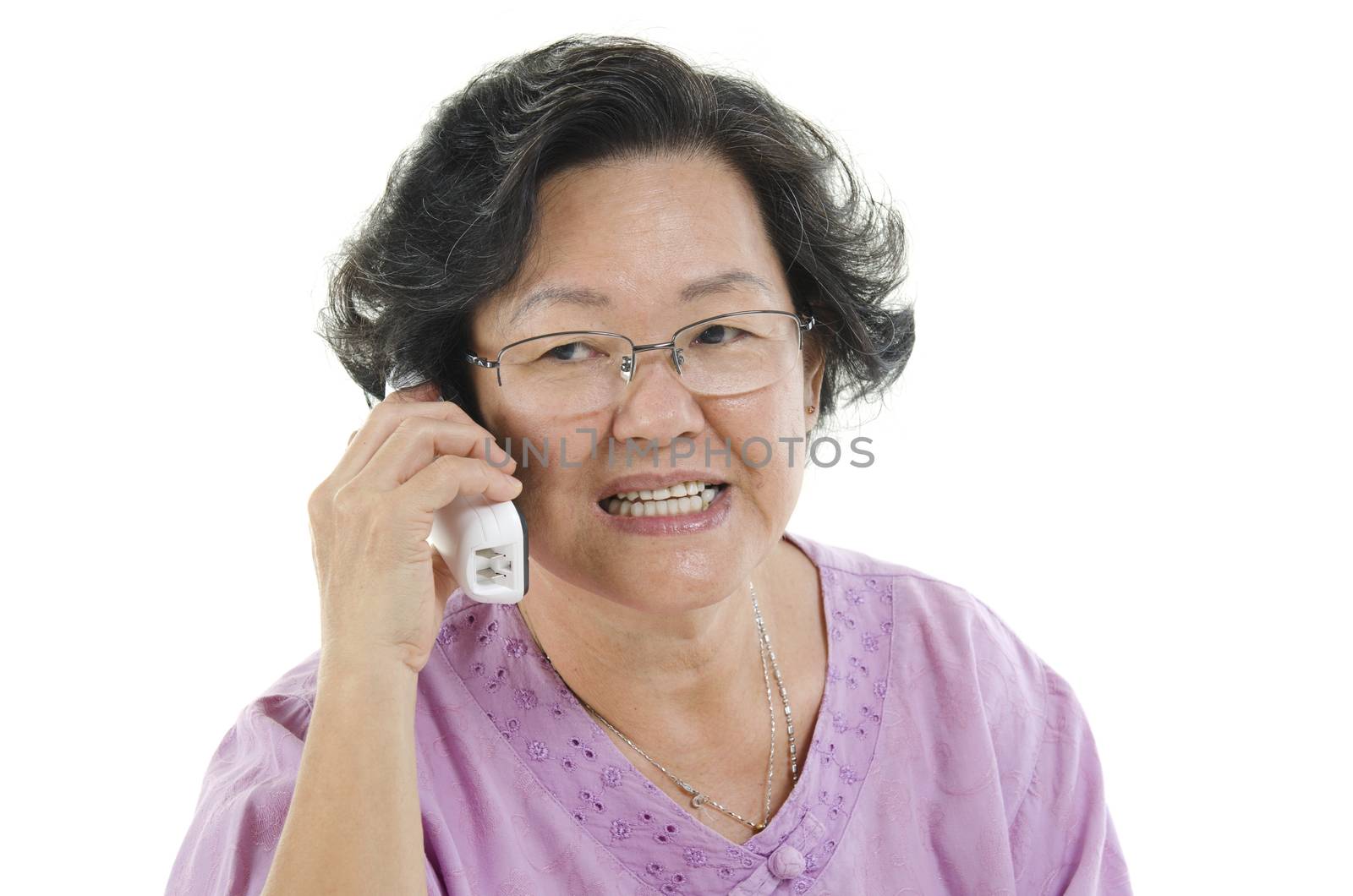 Portrait of 60s Asian senior adult woman talking on phone, isolated on white background.