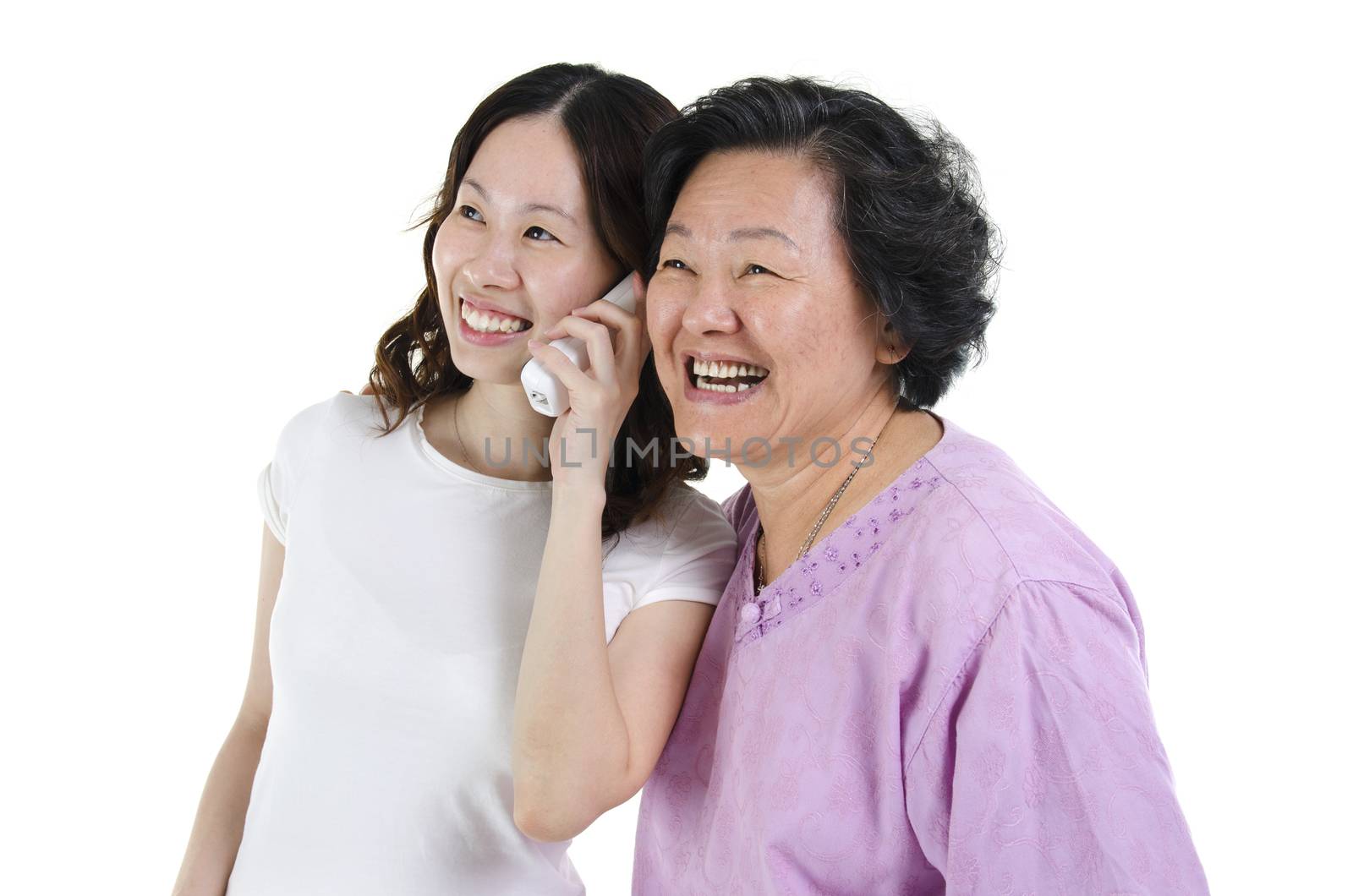 Portrait of Asian adult daughter calling on phone, sharing with senior mother and smiling, isolated on white background.