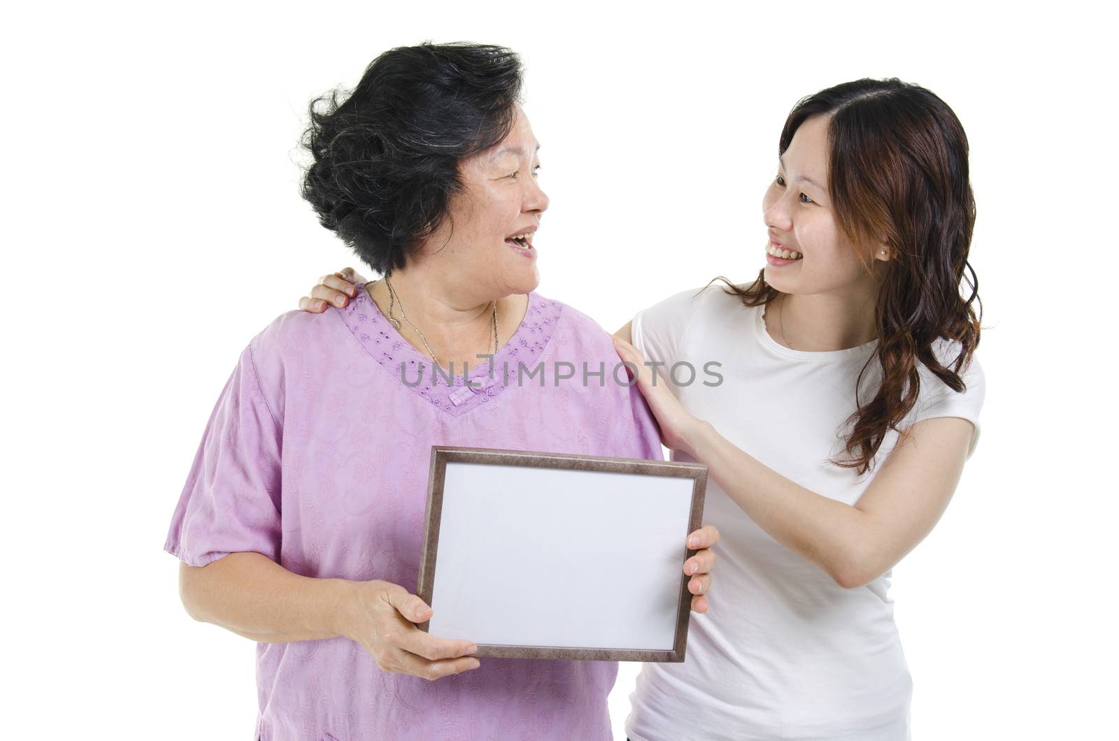 Portrait of Asian senior mother hand holding a white blank sign with adult daughter and smiling, isolated on white background.
