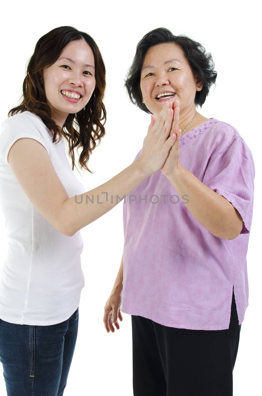 Portrait of Asian senior mother high five with adult daughter and smiling, isolated on white background.