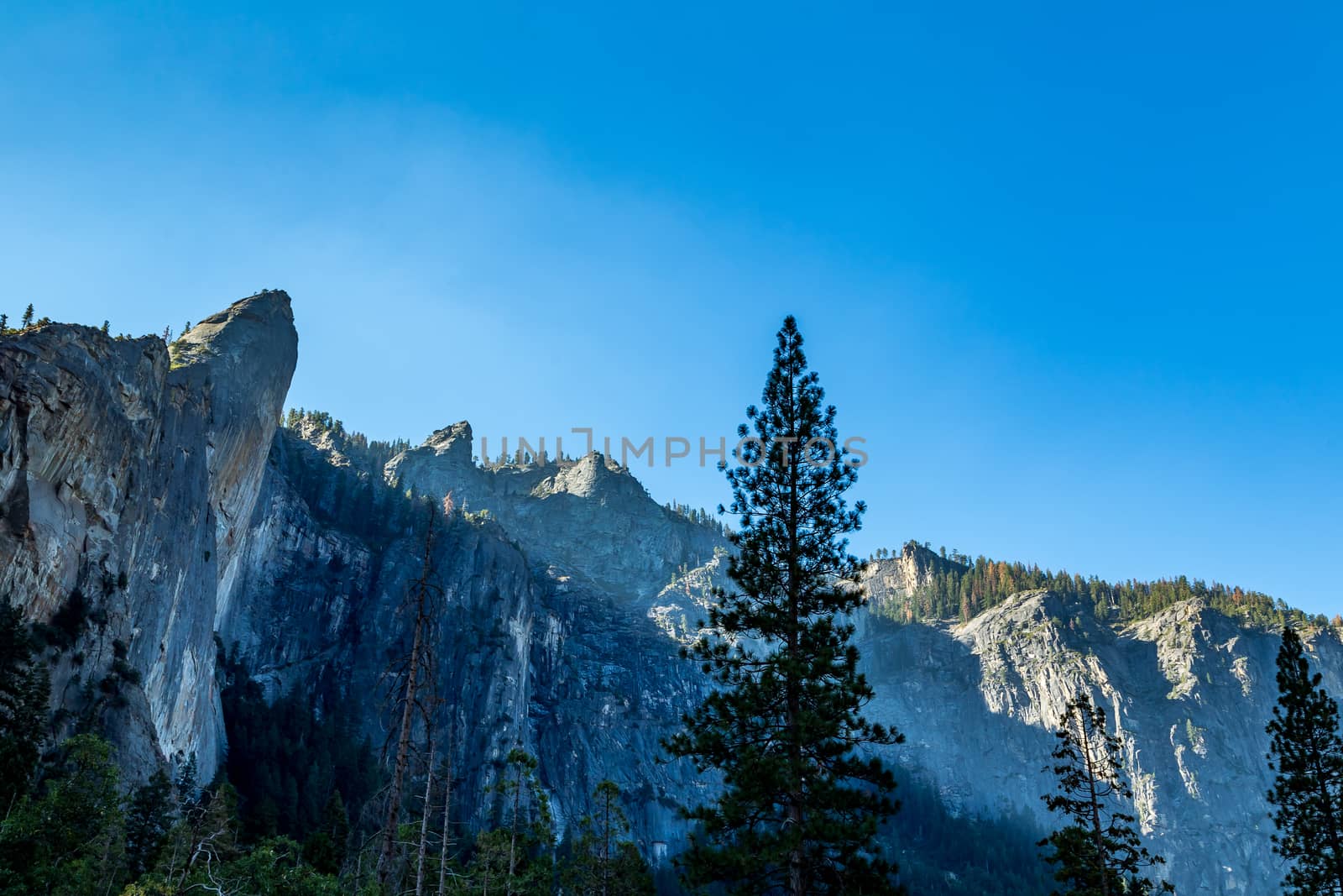 The Leaning Tower in Yosemite National Park is a popular destination for rock climbers. It is located west of, and adjacent to Bridalveil Fall, on the south side of the Merced River in Yosemite Valley. The rock is considered to be a strenuous climb, requiring approximately three days to climb to the summit. It is said to be a 700-foot (210 m) climb.