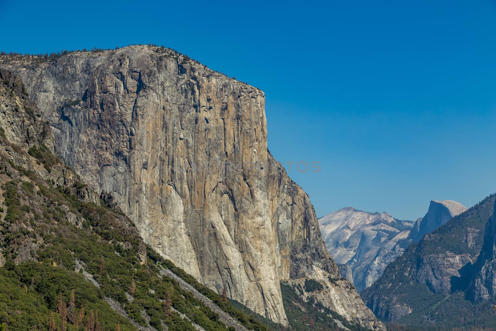 El Capitan (Spanish for The Captain, The Chief) is a vertical rock formation in Yosemite National Park, located on the north side of Yosemite Valley, near its western end. The granite monolith extends about 3,000 feet (900 m) from base to summit along its tallest face and is one of the world's favorite challenges for rock climbers and BASE jumpers.