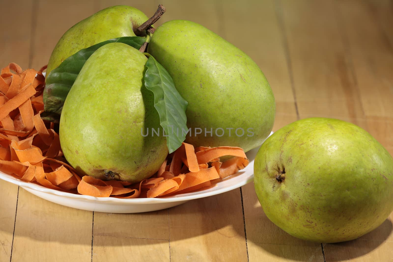 large ripe pears in the plate on the table