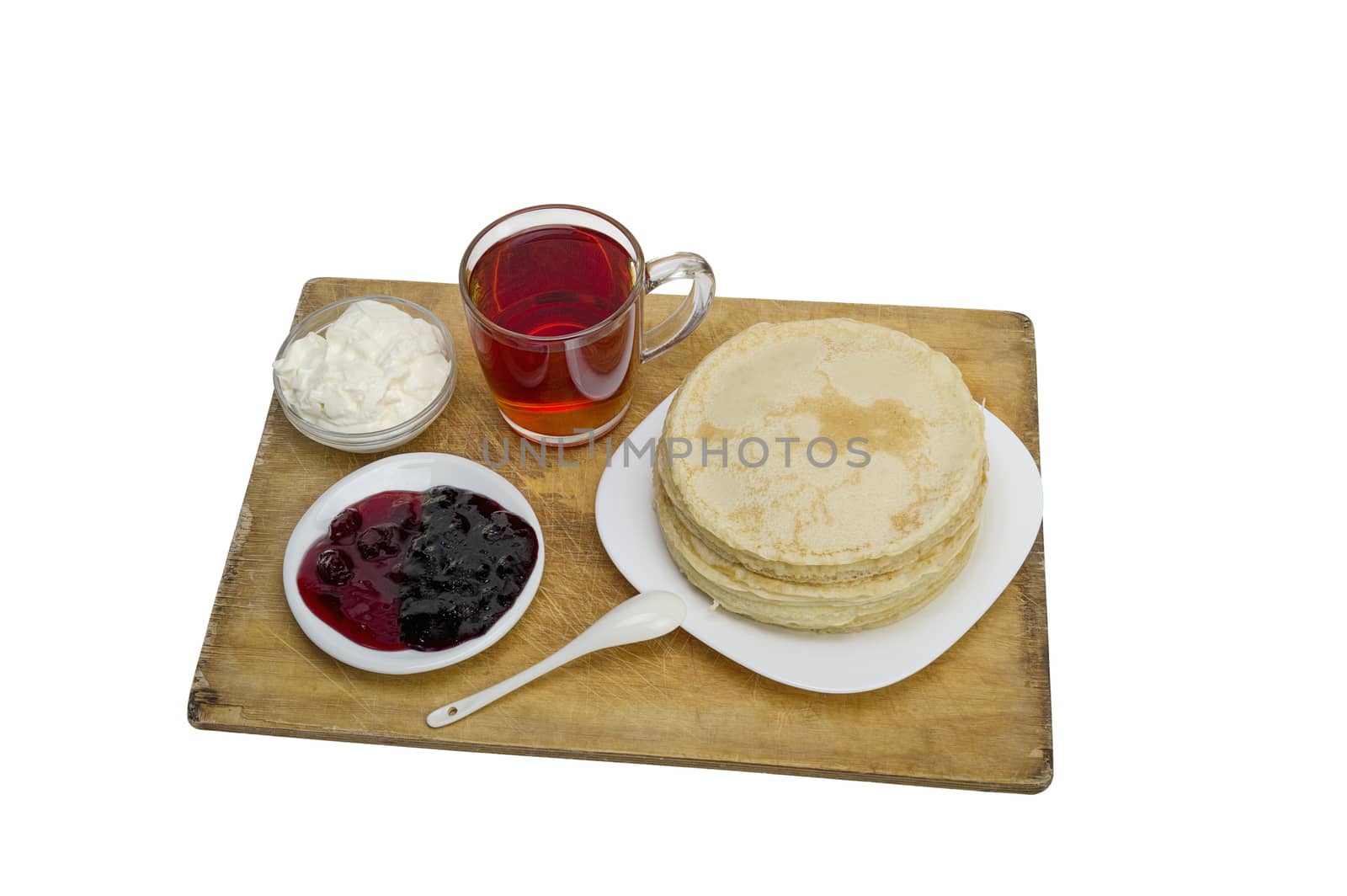 pancakes with jam and milk smeranoy on a wooden plank