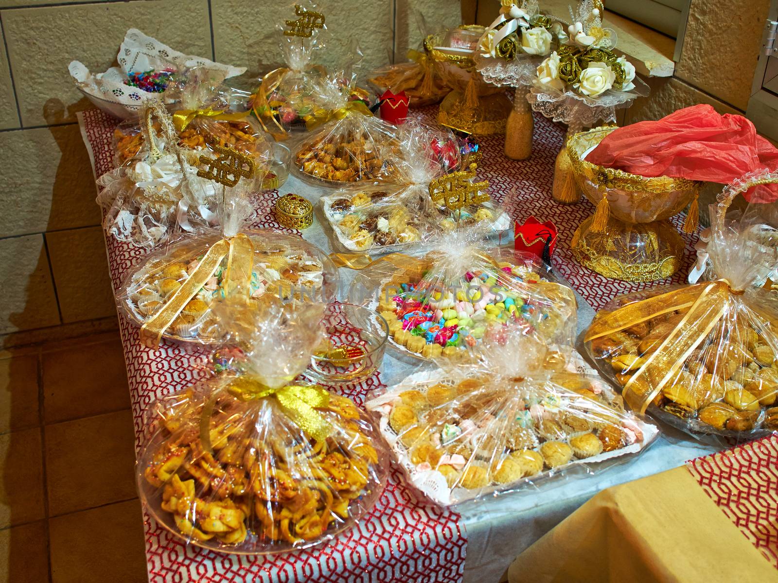 Wide selection of traditional eastern Arabic desserts sweets arranged on display in a festive celebration