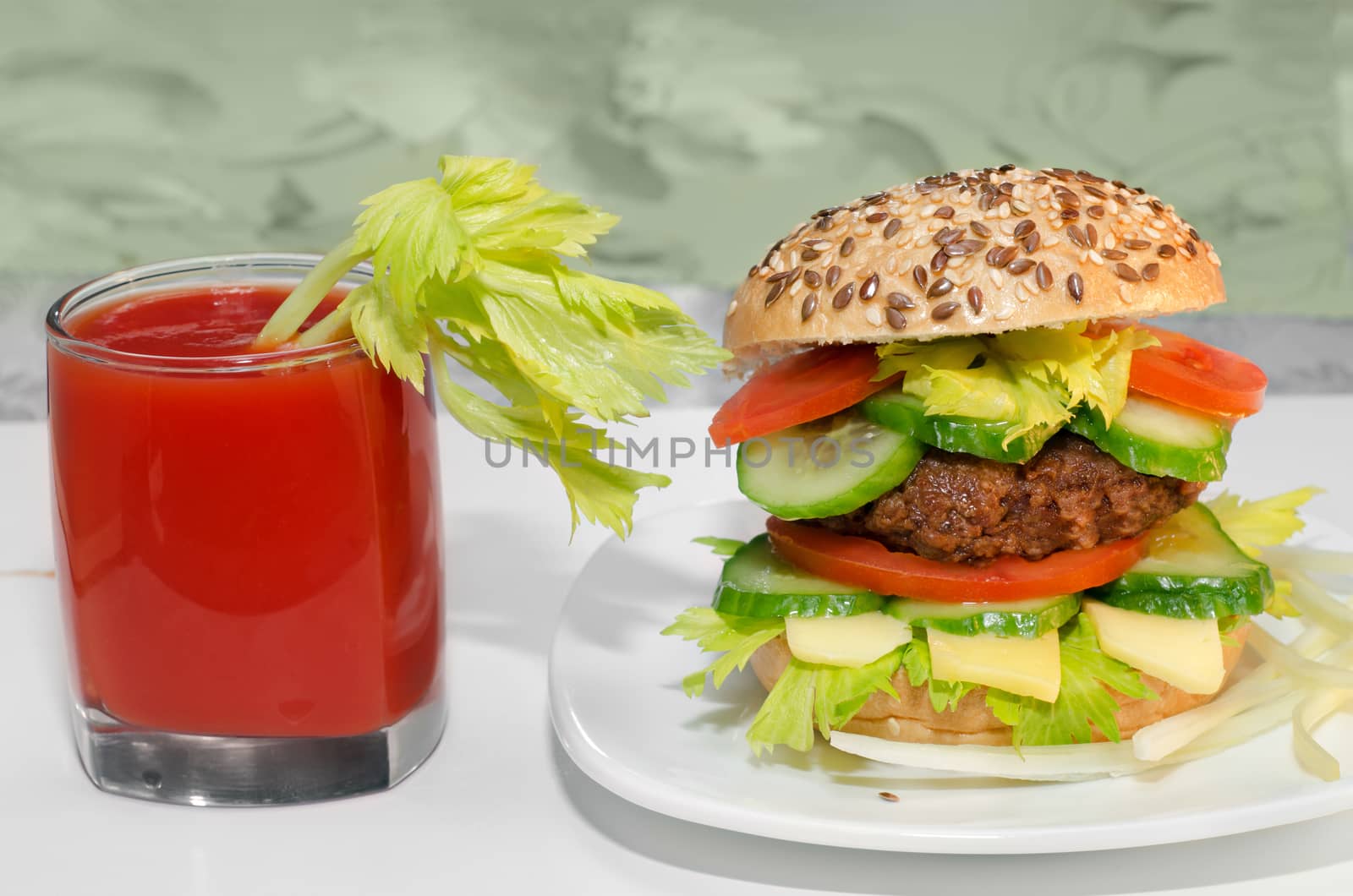 Great Burger and tomato juice with celery in the glass.