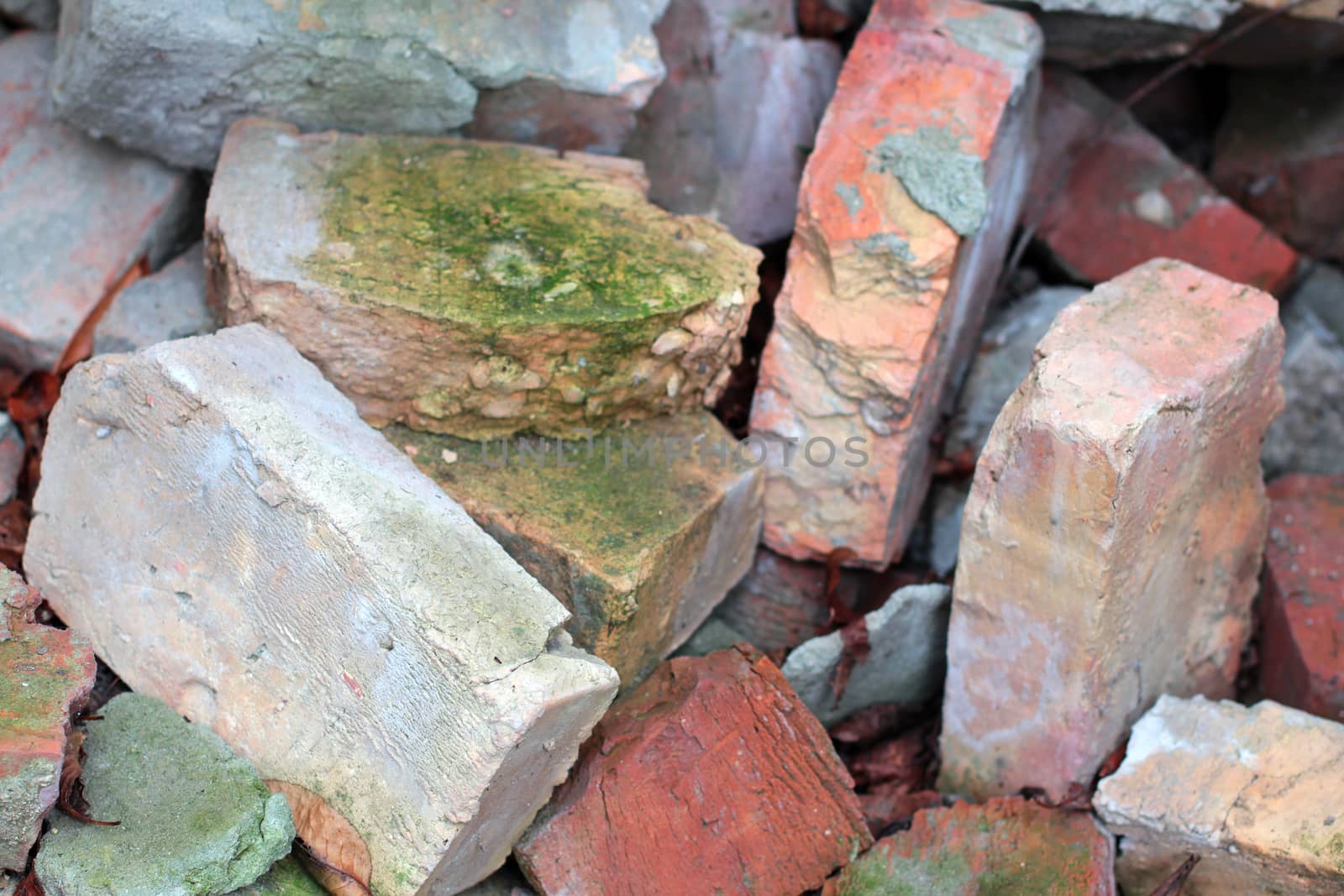 Old broken bricks covered with moss background