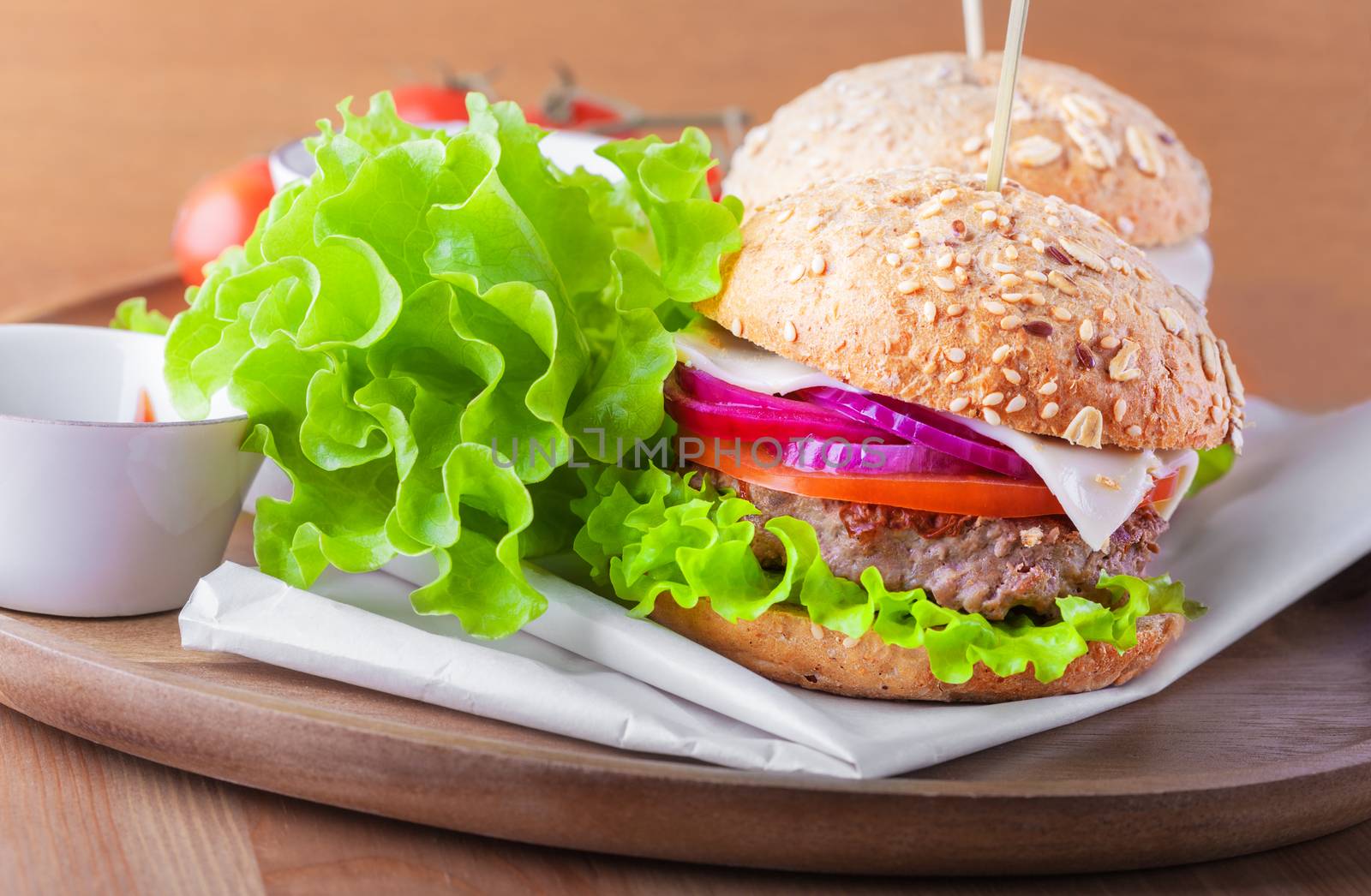 Cheeseburger with salad, onion tomato and fresh bread