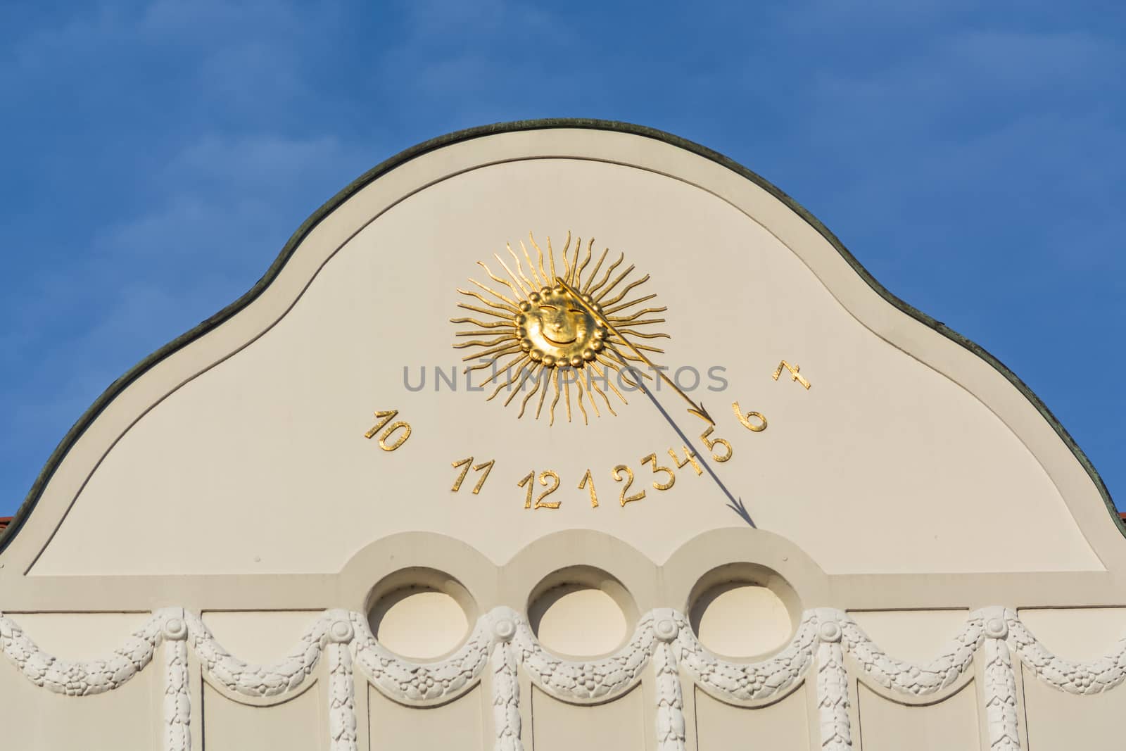 Sundial clock on a house facade by JFsPic