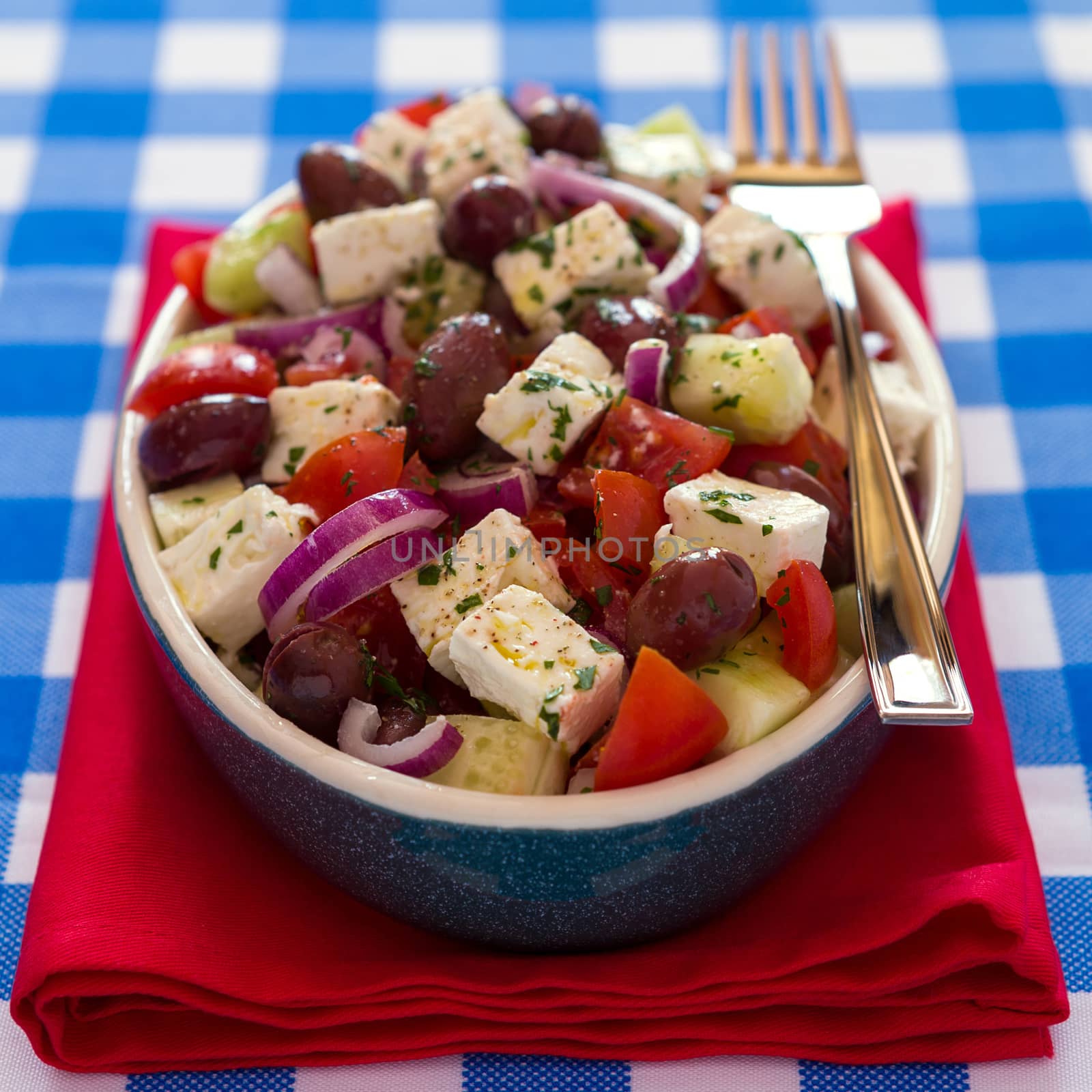 Greek salad with feta cheese olives tomatoes cucumber and onions by LuigiMorbidelli