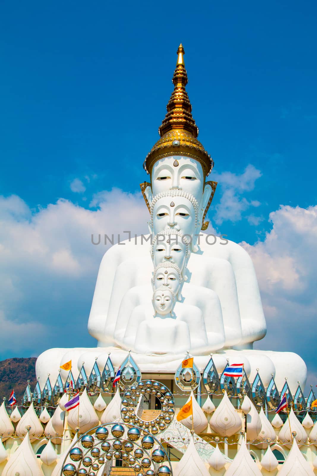 Phetchabun, Thailand - February 23.2017: Buddha statues and colored foot path colorful glass stacked in Wat Pha Kaew, Khao Kho, Phetchabun on February 23.2017 at Thailand.There. A famous Buddhist temple.