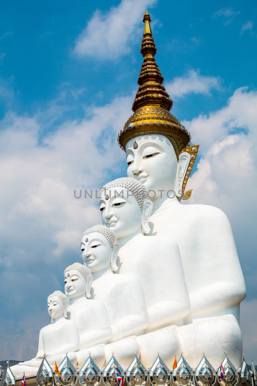 Phetchabun, Thailand - February 23.2017: Buddha statues and colored foot path colorful glass stacked in Wat Pha Kaew, Khao Kho, Phetchabun on February 23.2017 at Thailand.There. A famous Buddhist temple.