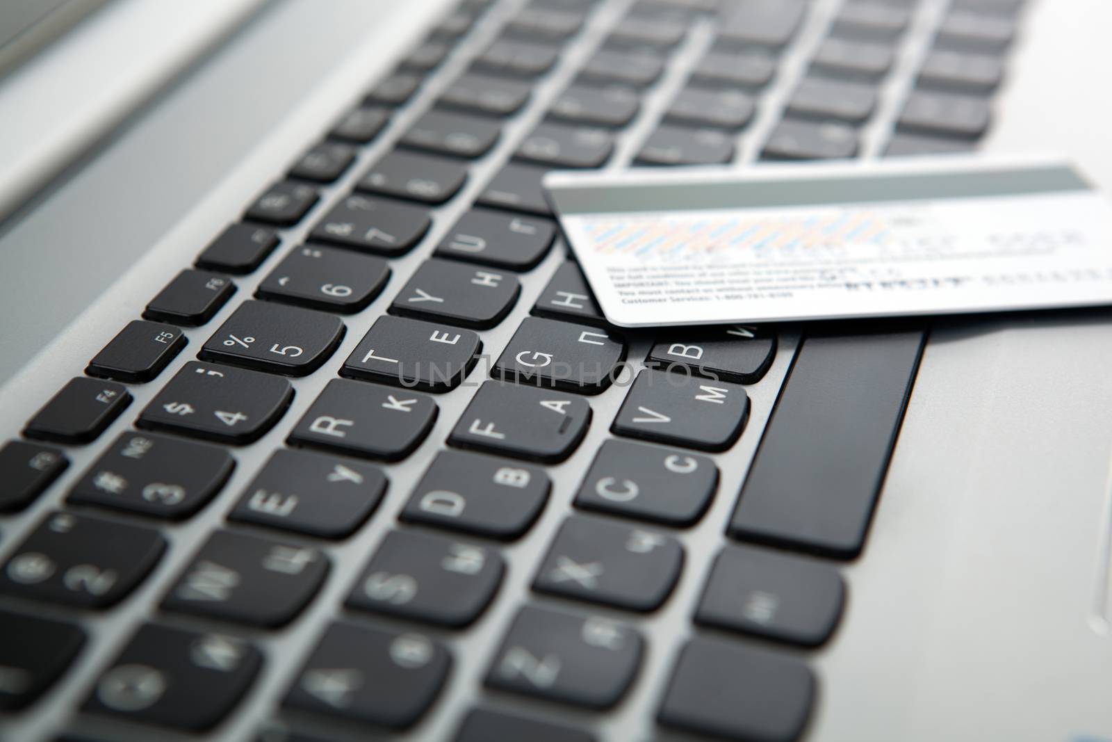 bank card lies on the laptop keyboard close up