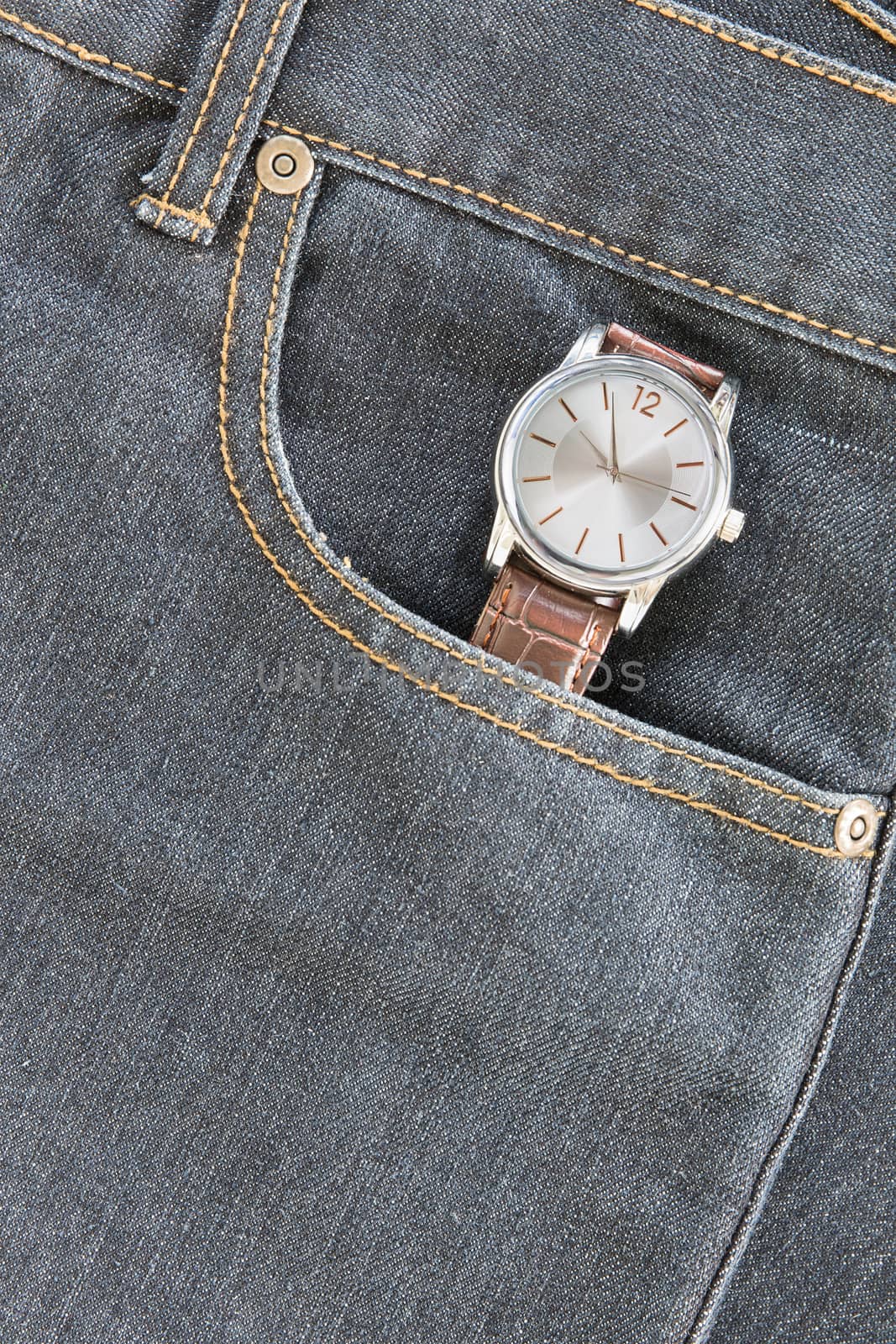 Wristwatch in denim jeans pocket by stoonn