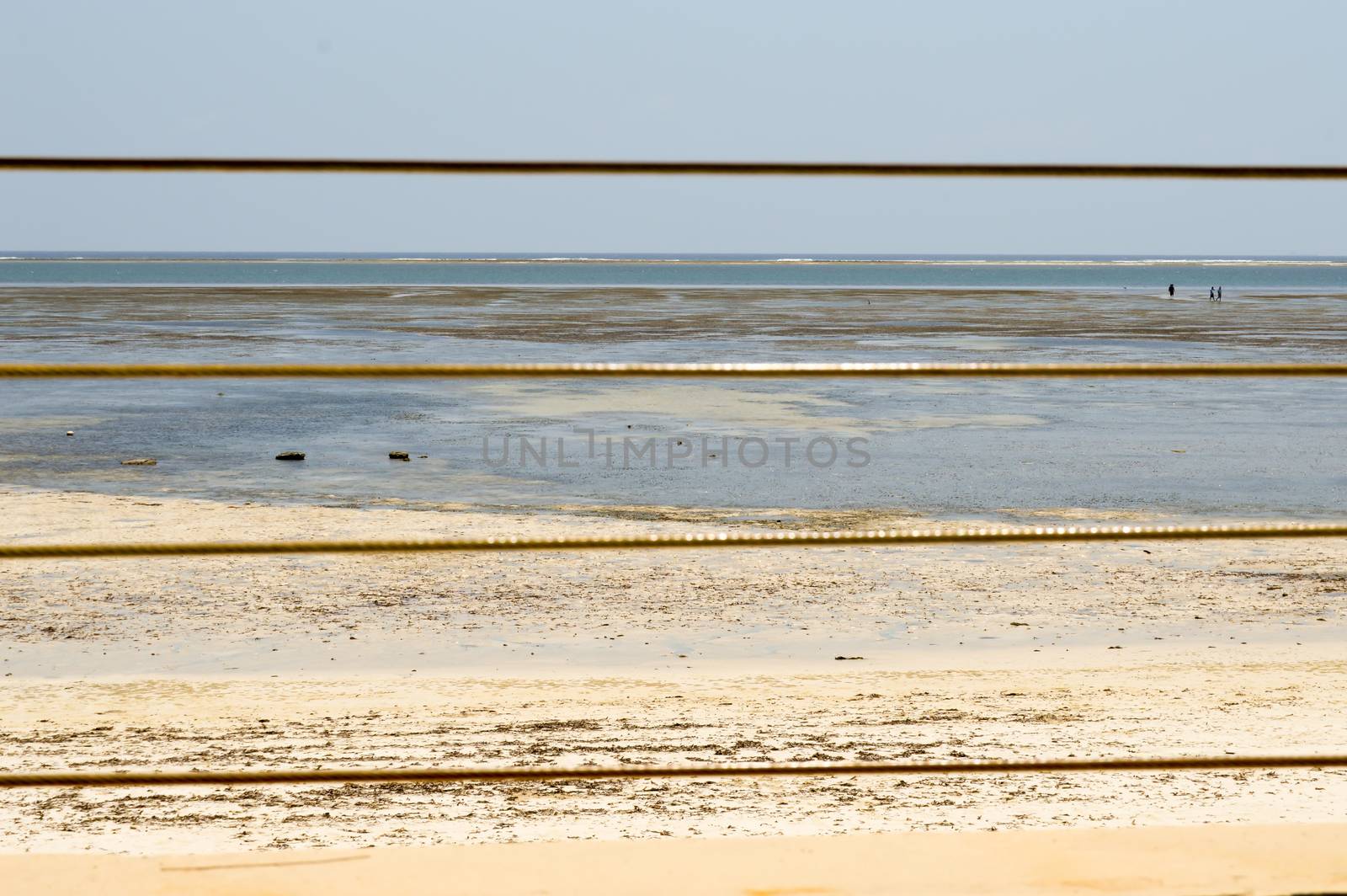 Yellow steel cable with the ocean in background on the beach of Bamburi in Kenya