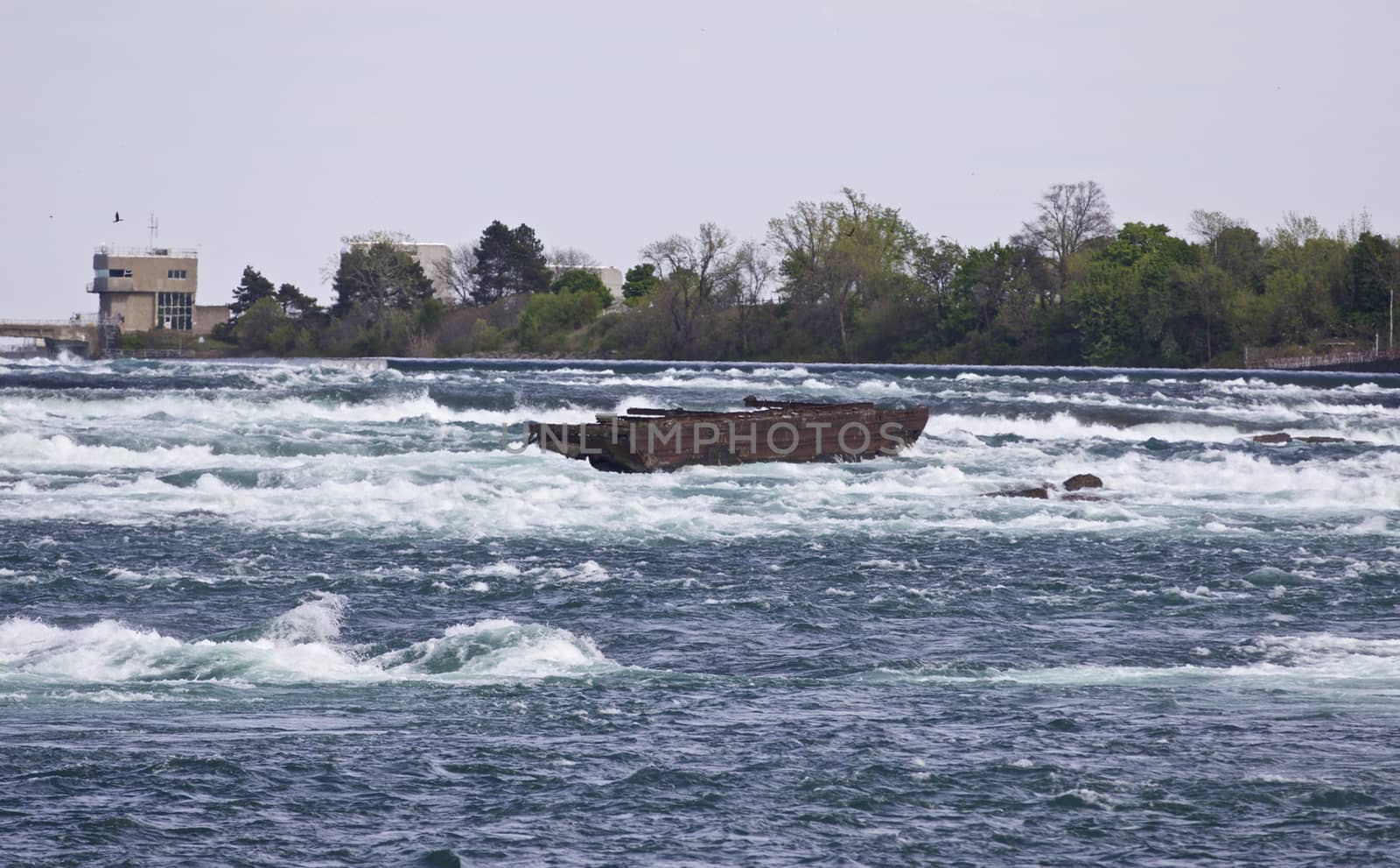 Beautiful image with a broken boat on the river right before the amazing Niagara falls by teo