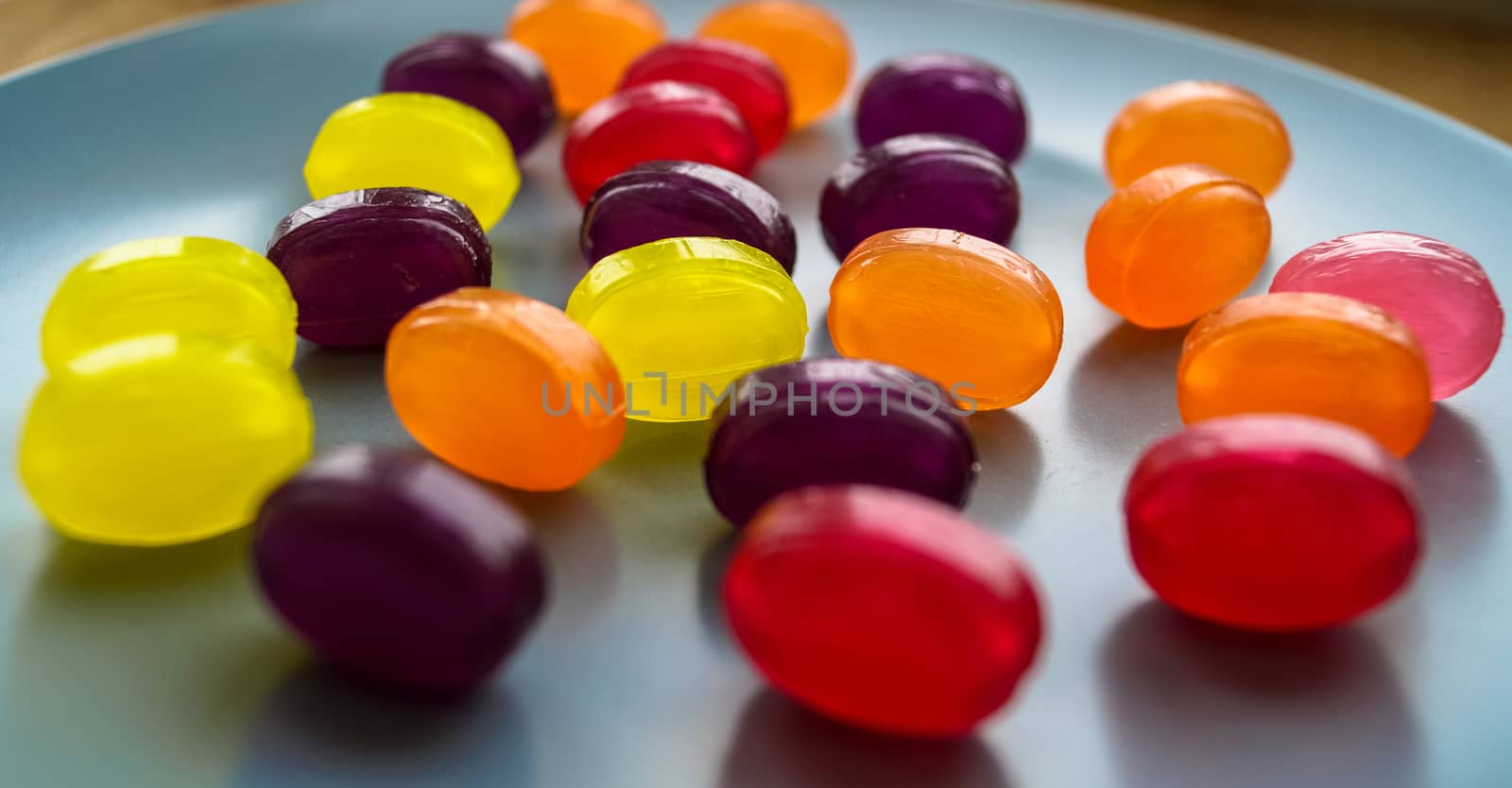 colored candy lollipops laid out on the plate