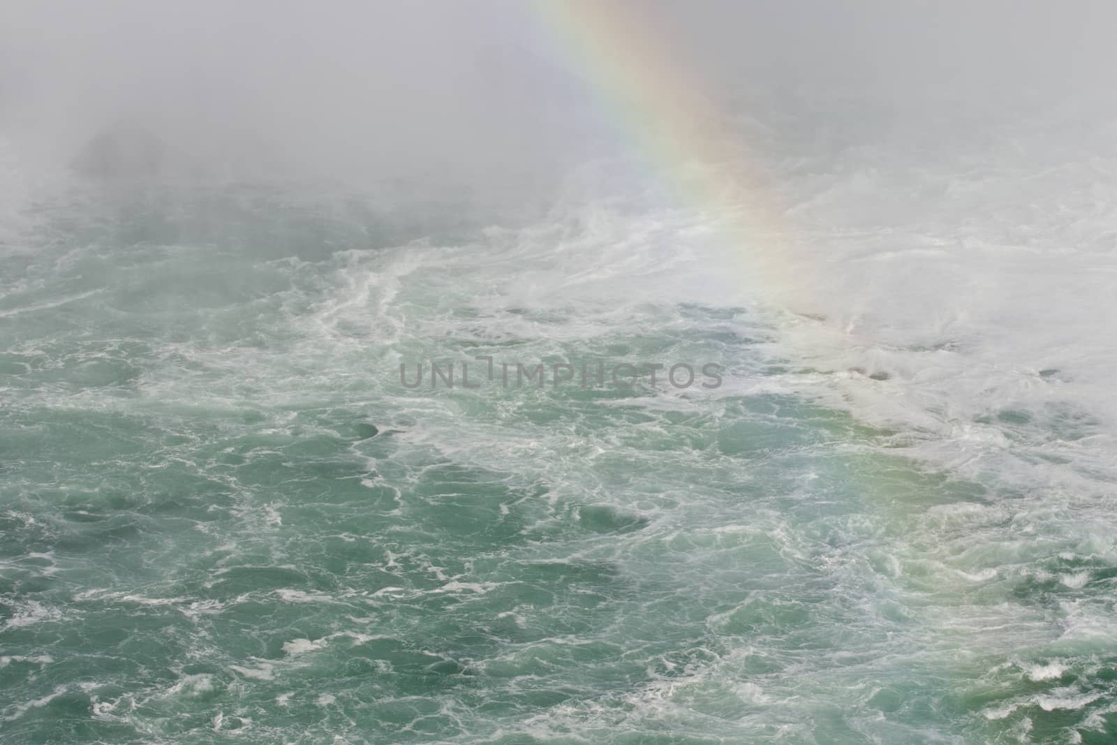 Beautiful photo of the water near amazing Niagara falls with a rainbow