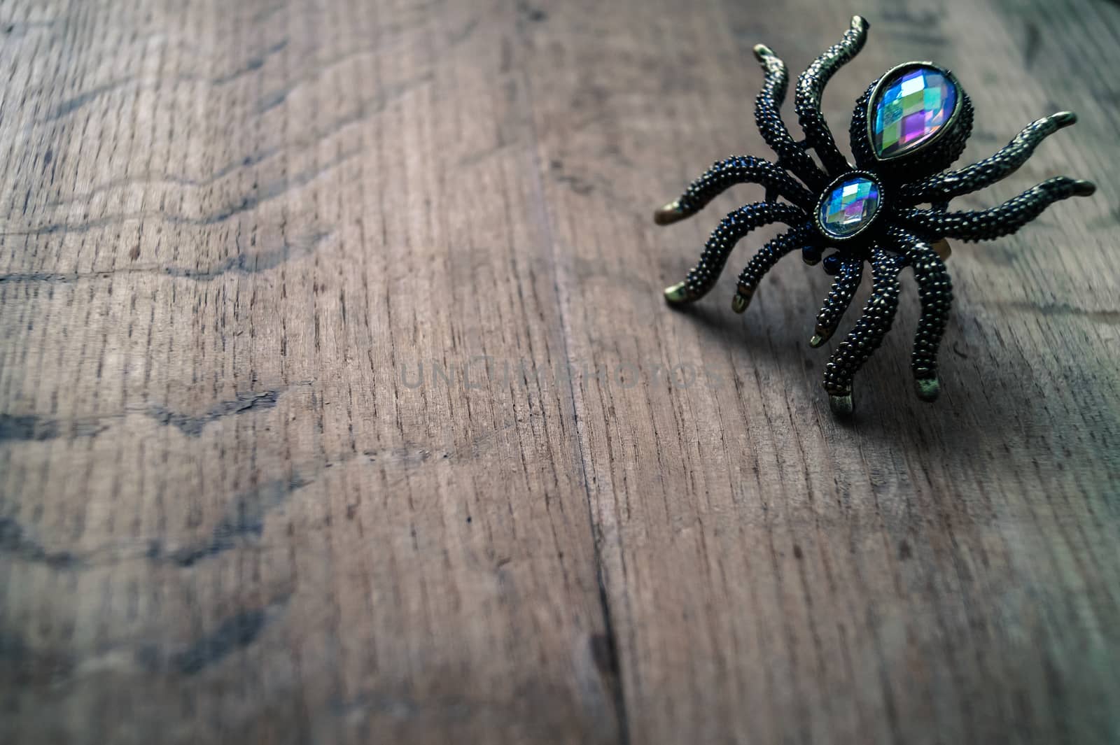 spider ring on a wooden table jewelry