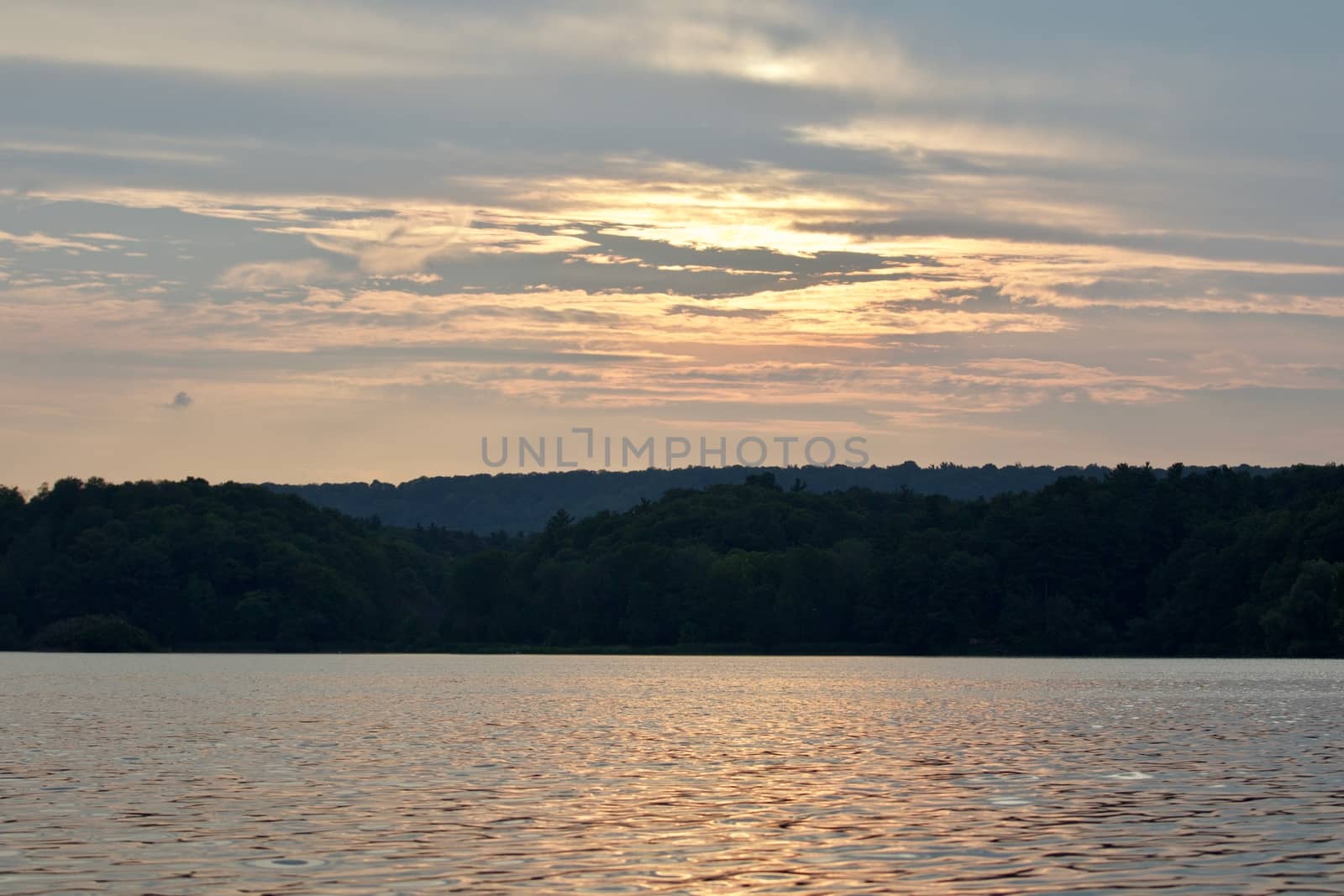 Beautiful isolated image with the lake and the forest on the sunset by teo