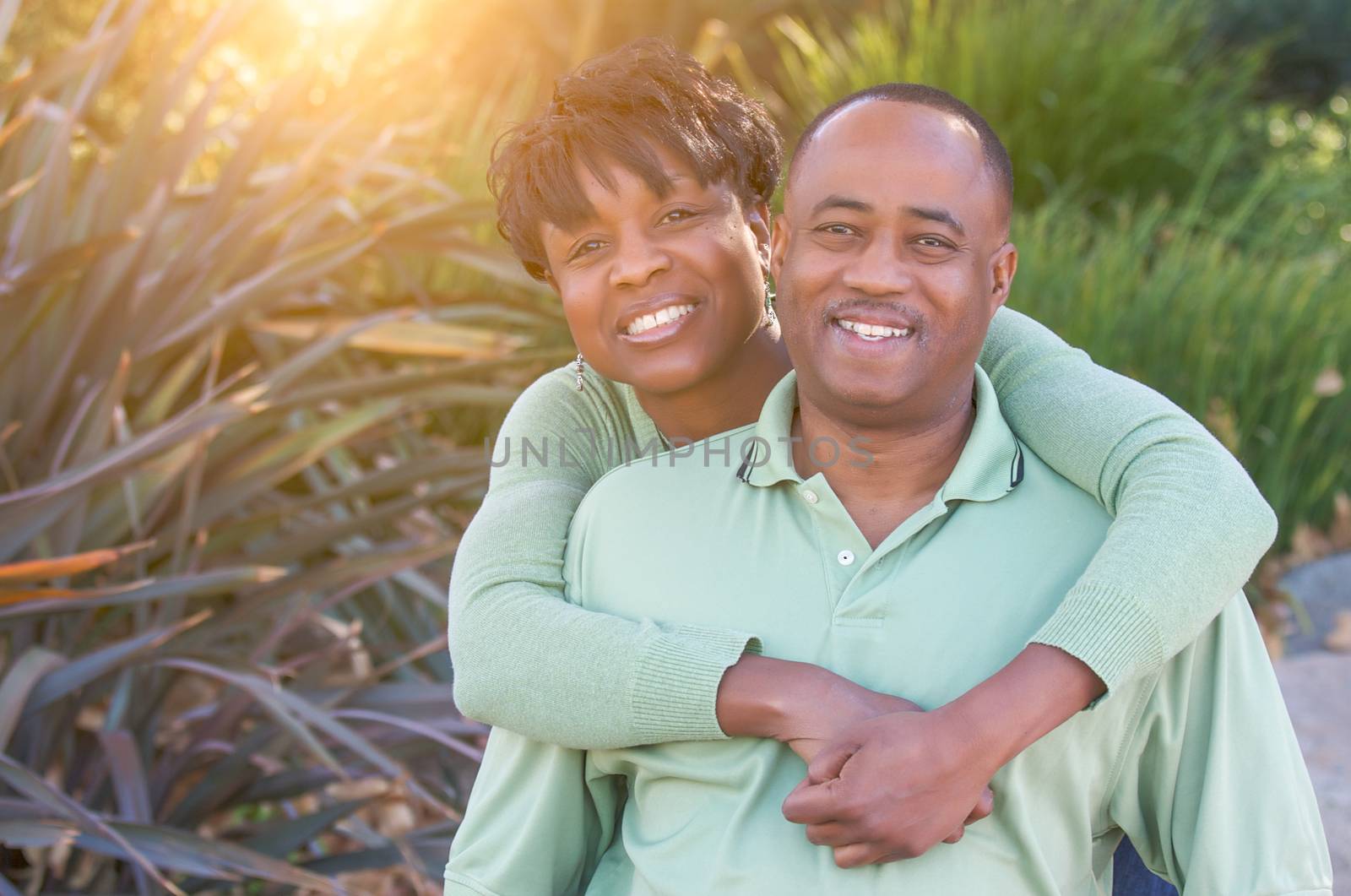 Attractive and Affectionate African American Couple posing in the park.