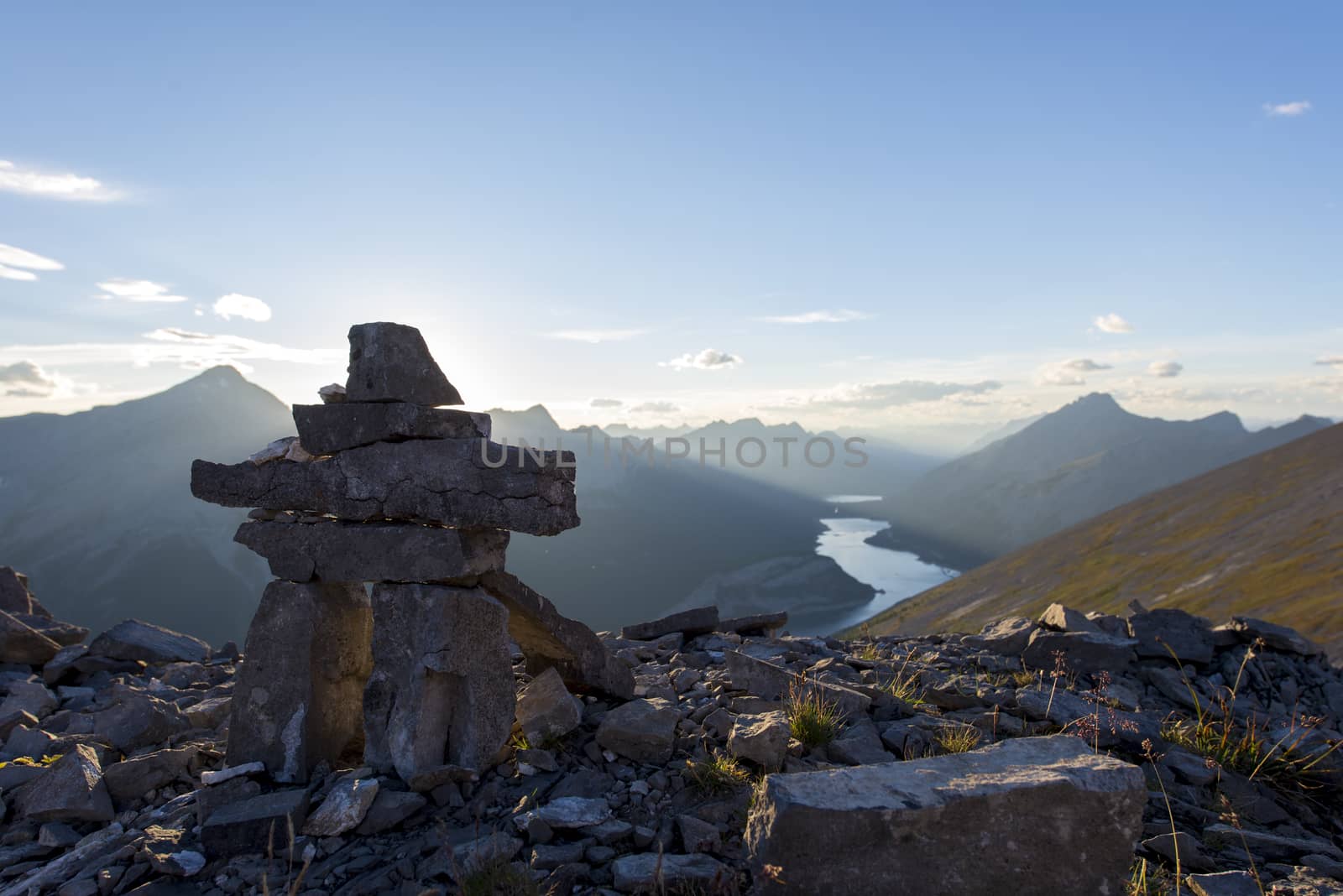 Inukshuk rock sculpture at the summit of a hiking trail in the rockies