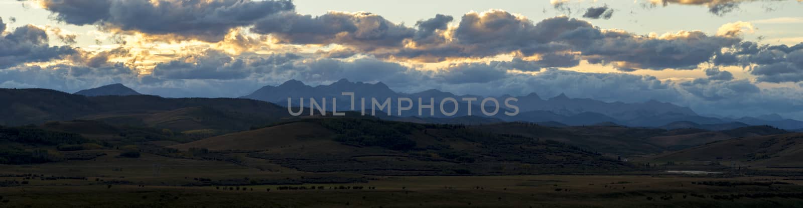 Orange sunset illuminating the mountains near the edge of the rockies