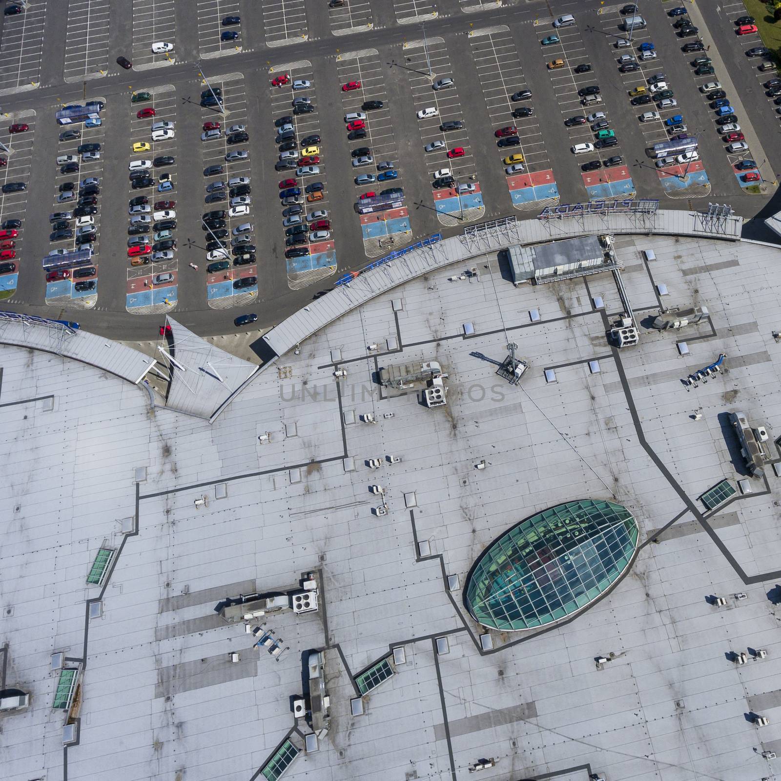 Supermarket roof and many cars in parking, viewed from above. by mariusz_prusaczyk