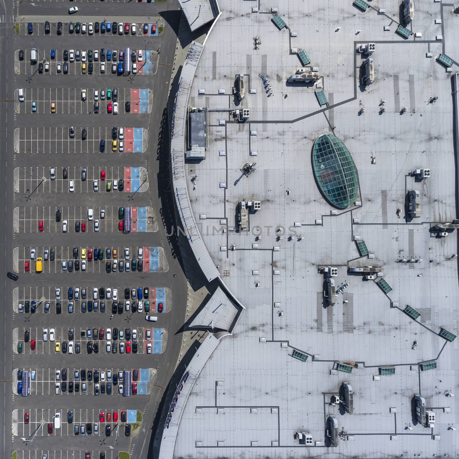 Supermarket roof and many cars in parking, viewed from above. by mariusz_prusaczyk