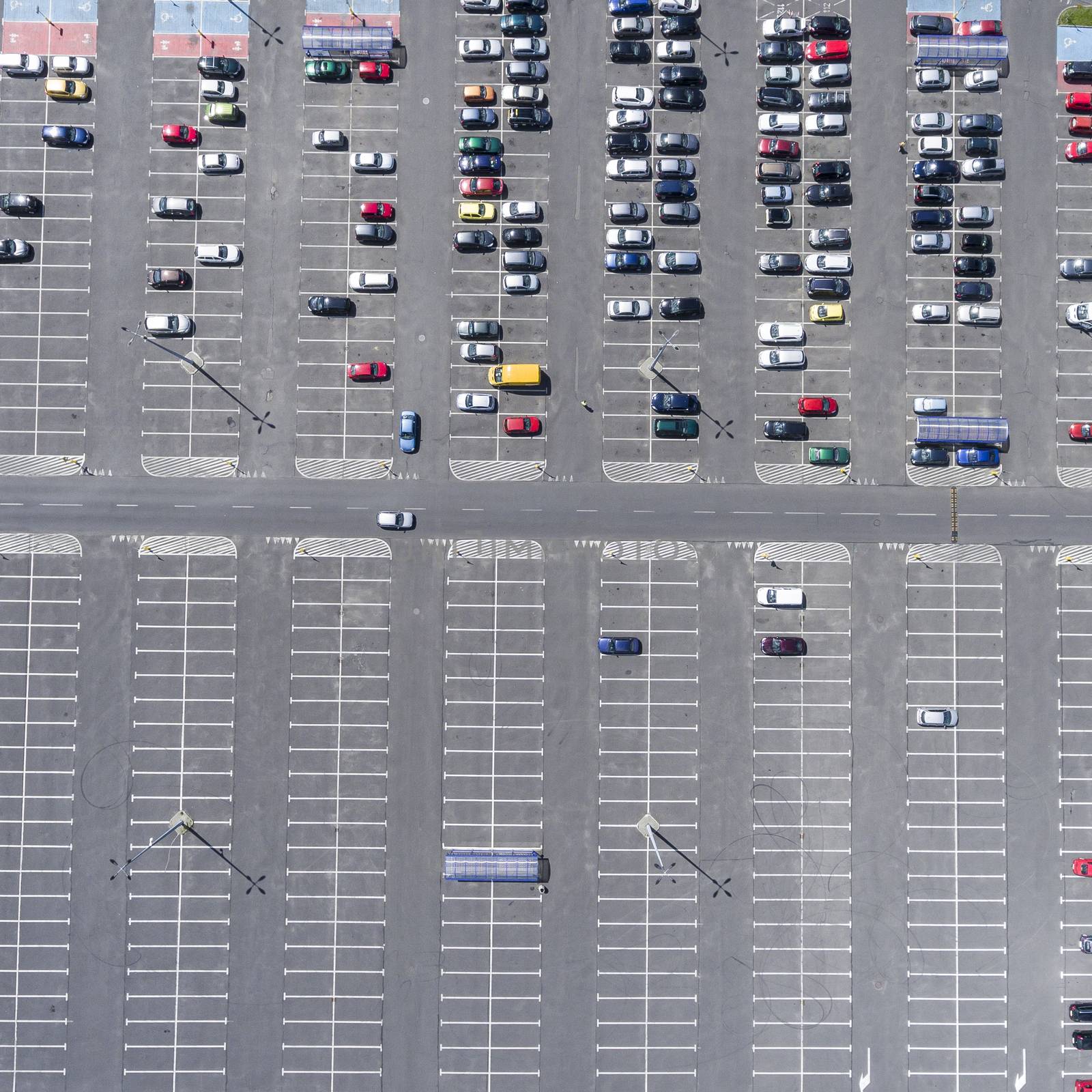 Supermarket roof and many cars in parking, viewed from above. by mariusz_prusaczyk