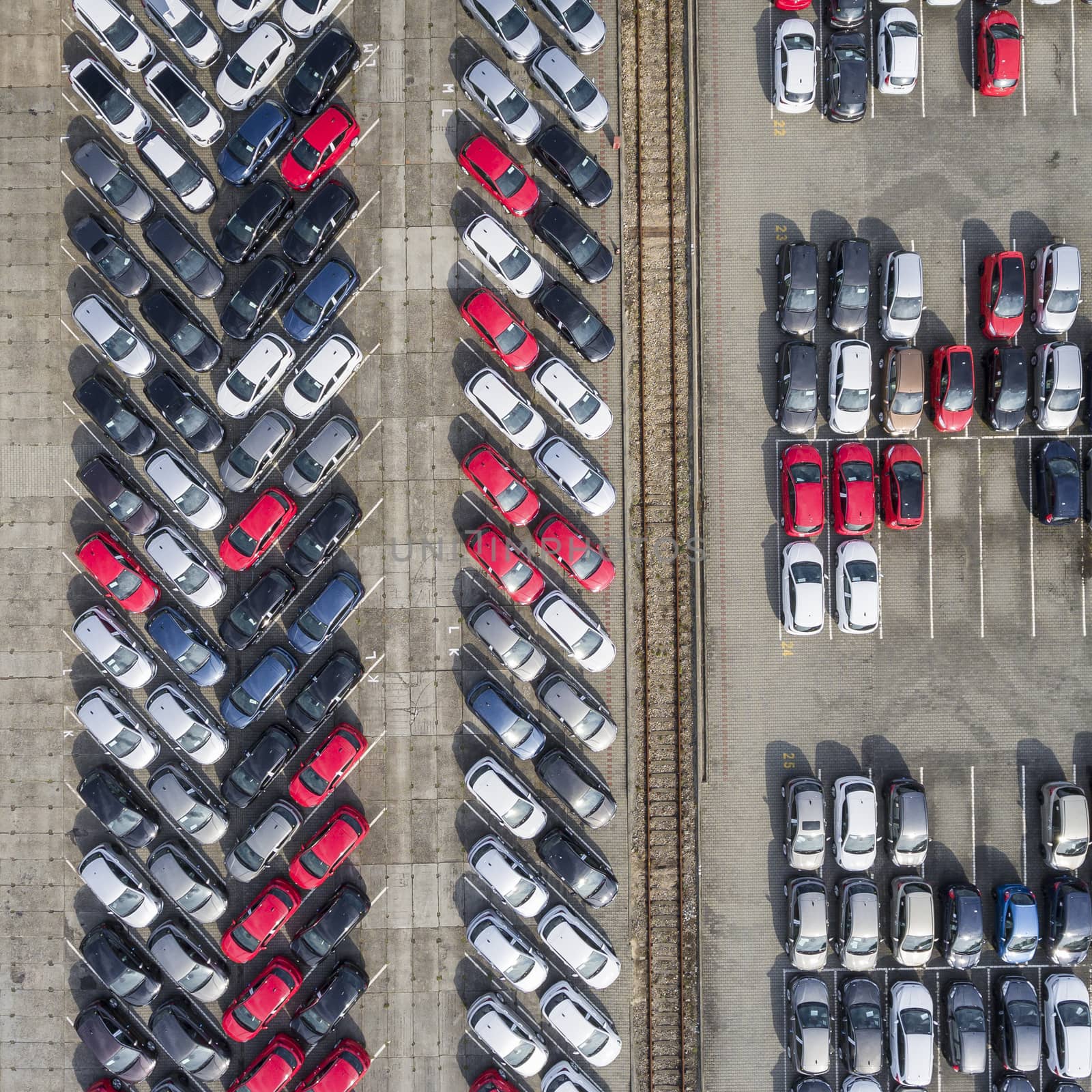 Aerial view lot of vehicles on parking for new car. by mariusz_prusaczyk