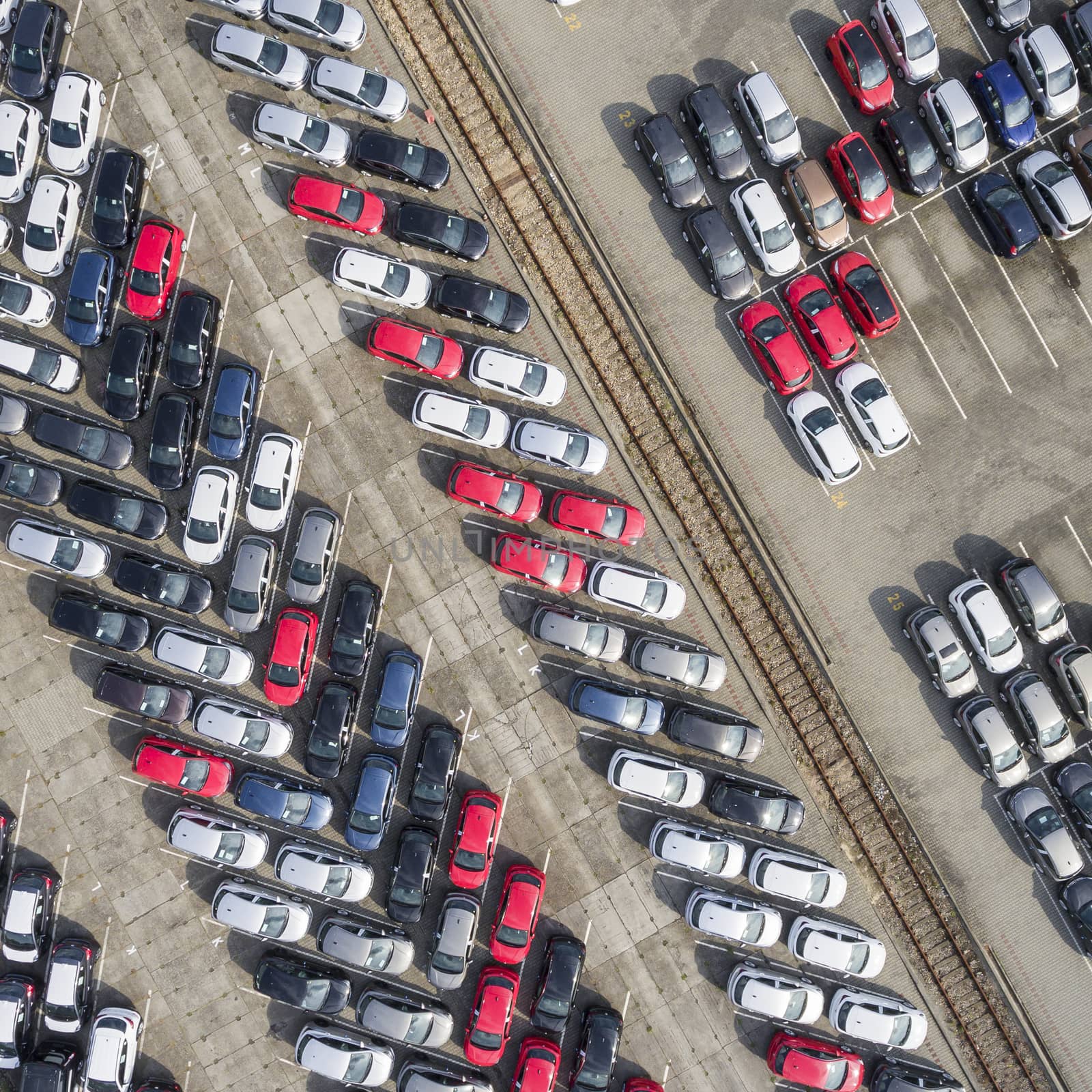 Aerial view lot of vehicles on parking for new car. by mariusz_prusaczyk