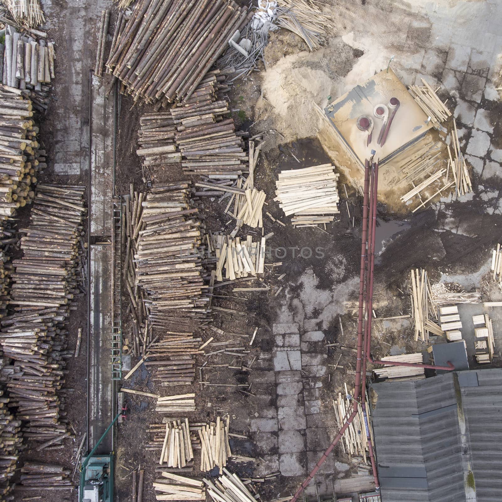 Sawmill. Felled trees, logs stacked in a pile. View from above. Industrial background.