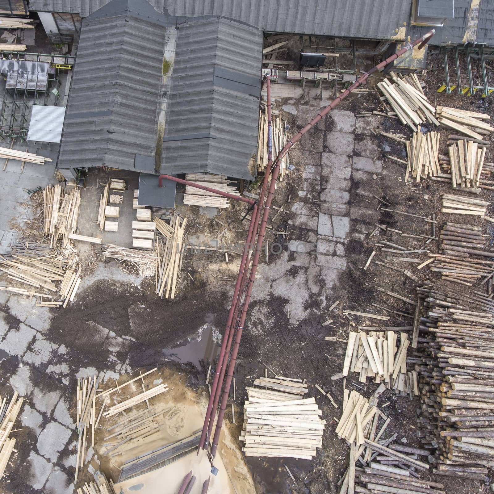 Sawmill. Felled trees, logs stacked in a pile. View from above.  by mariusz_prusaczyk