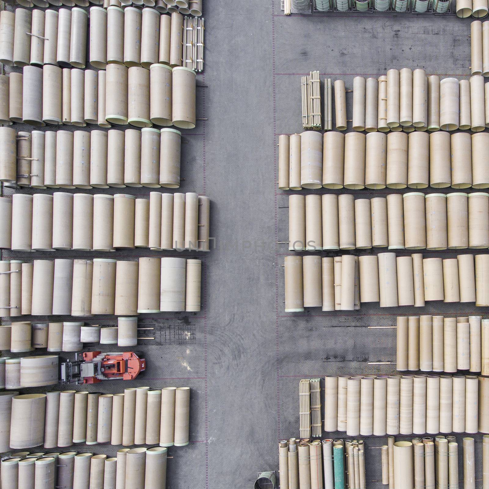 Industrial concrete drainage pipes stacked for construction. New tubes. Storage place. View from above.