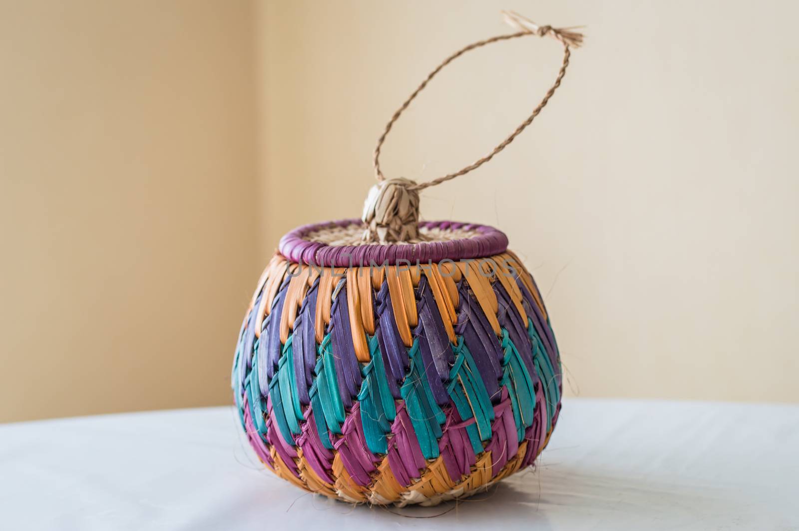 color braided bamboo basket on the table